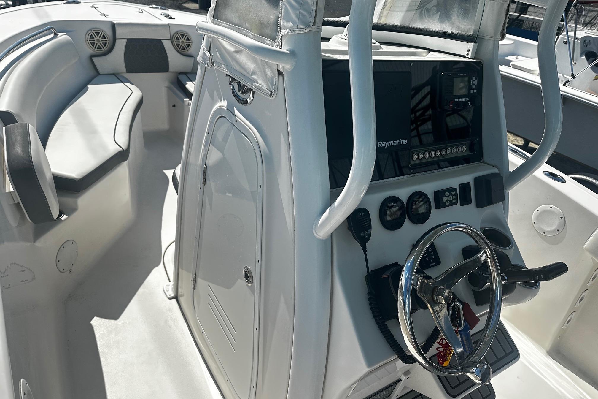 2020 Tidewater 230 CC Adventure boat interior with steering console and seating area.