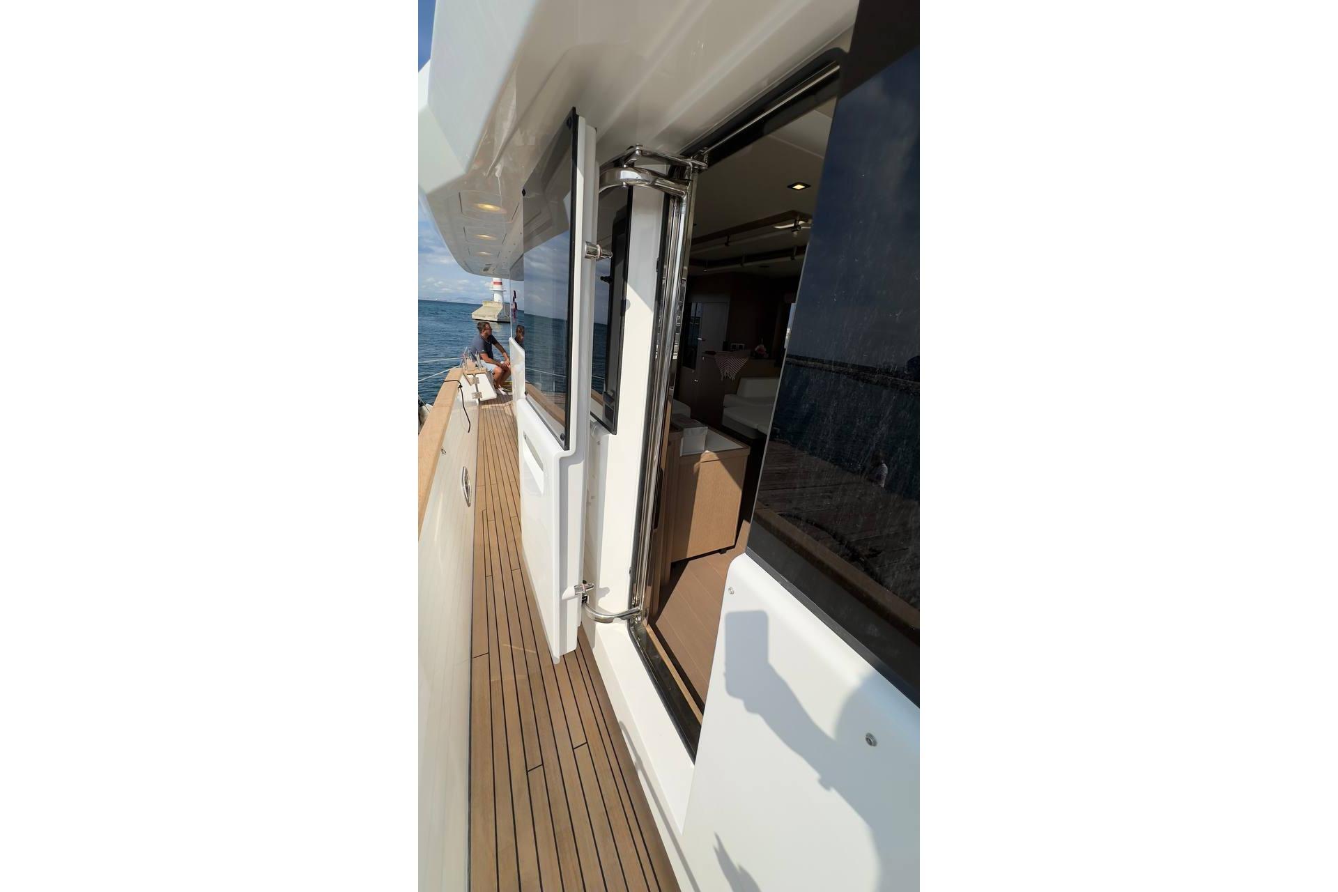 2024 Sirena 58 Fly yacht deck with open door, ocean view.