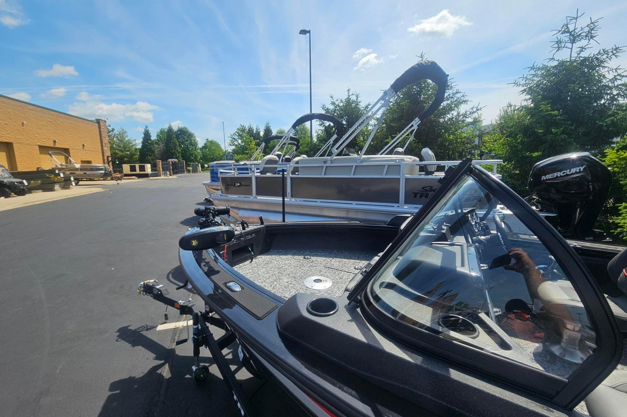 2026 Tracker Targa V-19 Combo boat with Mercury engine in outdoor showroom.