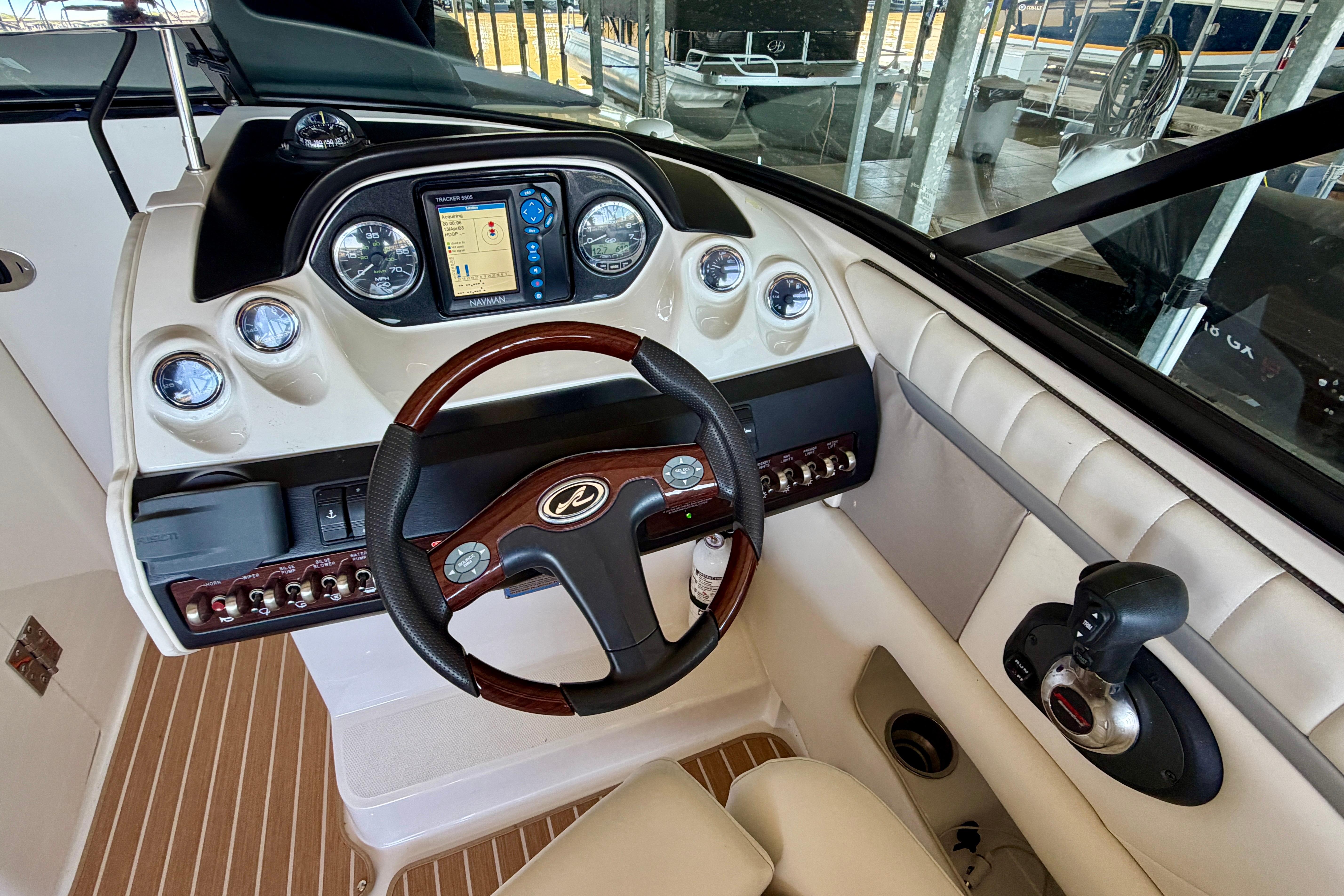 2007 Sea Ray 270 SLX boat dashboard with steering wheel and navigation controls.