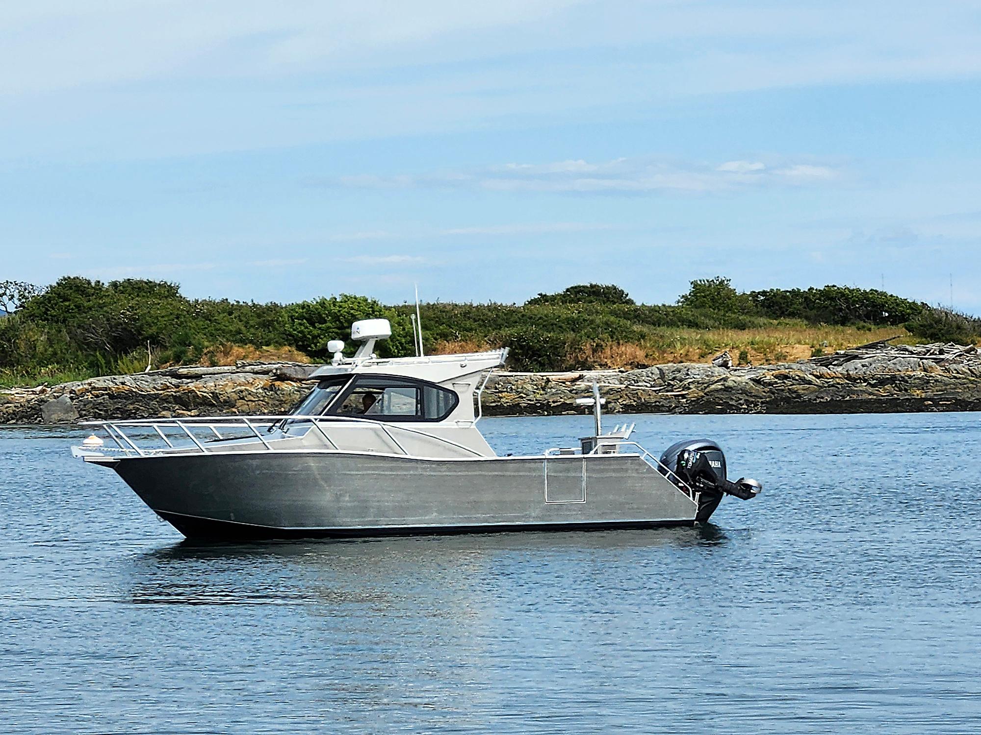2024 Gospel Boat Profisher 750 on calm water, scenic background.