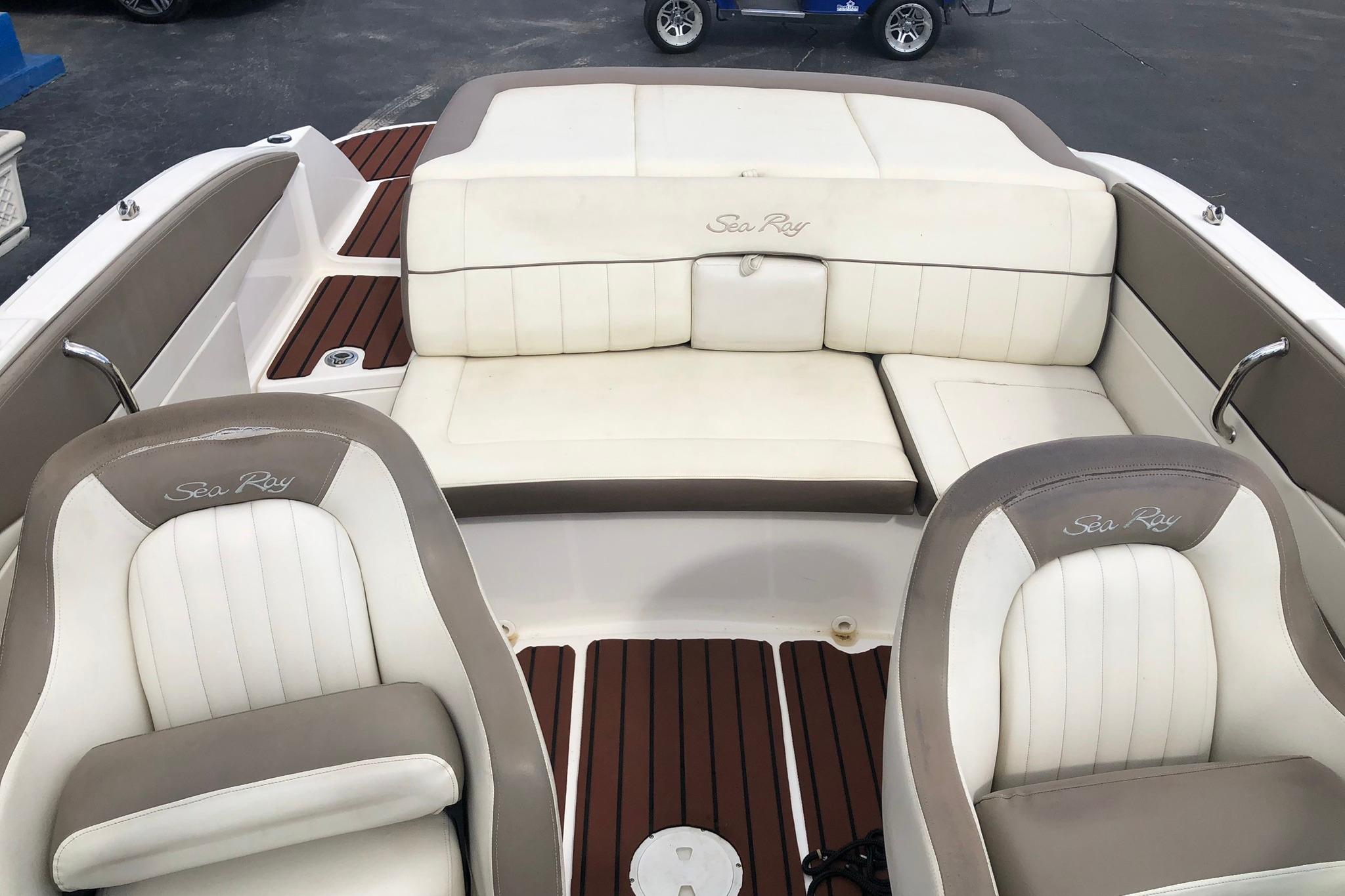 2012 Sea Ray 210 SLX boat interior with white and beige seating, wood accents.