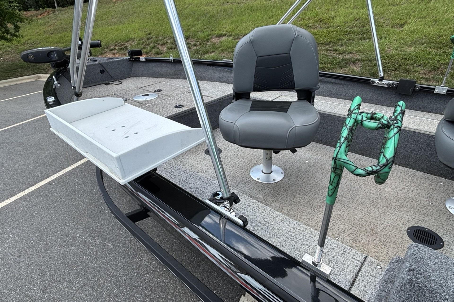 2022 Tracker Super Guide V-16 T boat interior with seating and fishing rod holder.