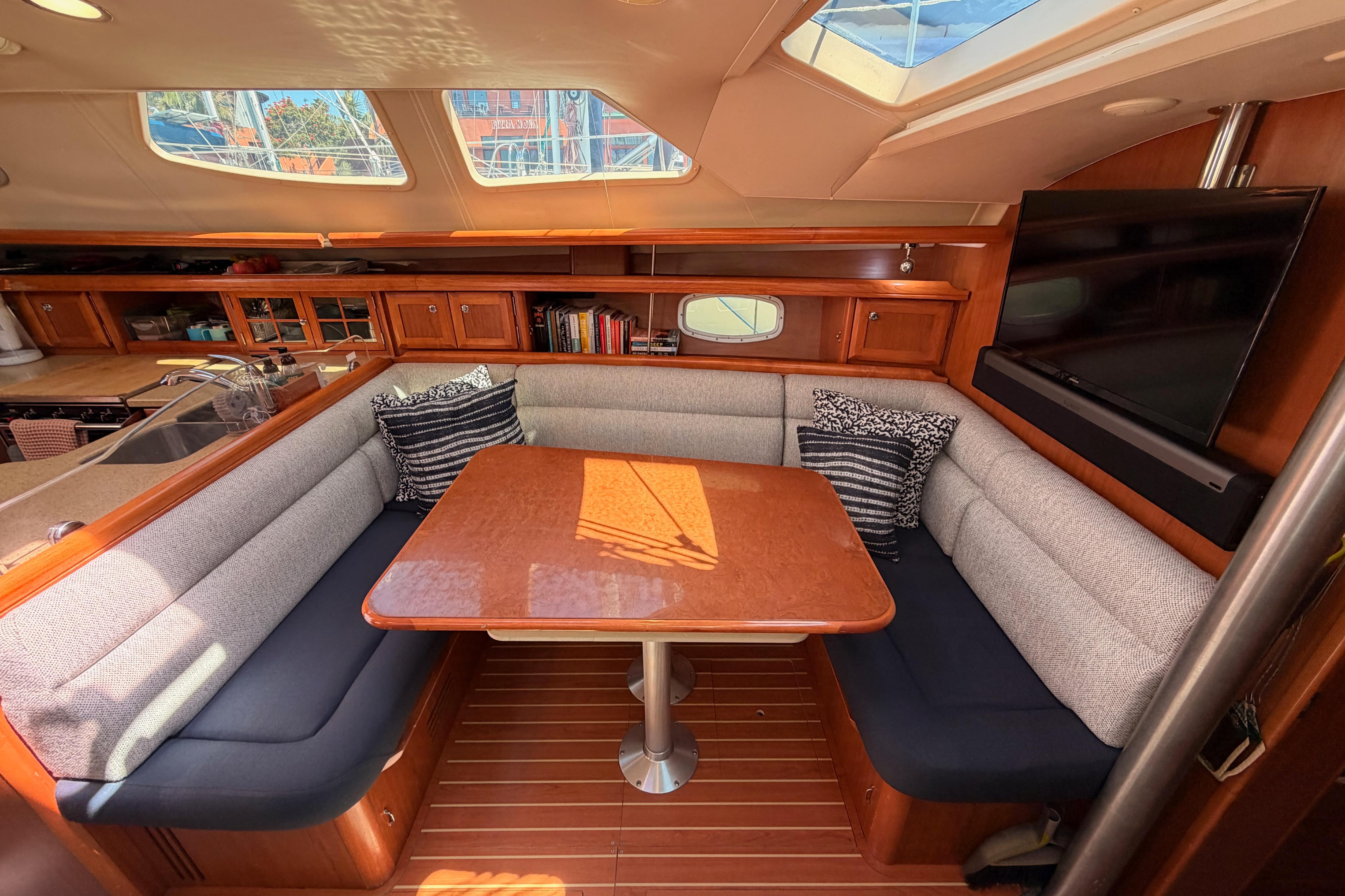 Luxurious interior of 2008 Hunter 45 Deck Salon with cozy seating and elegant wood finishes.
