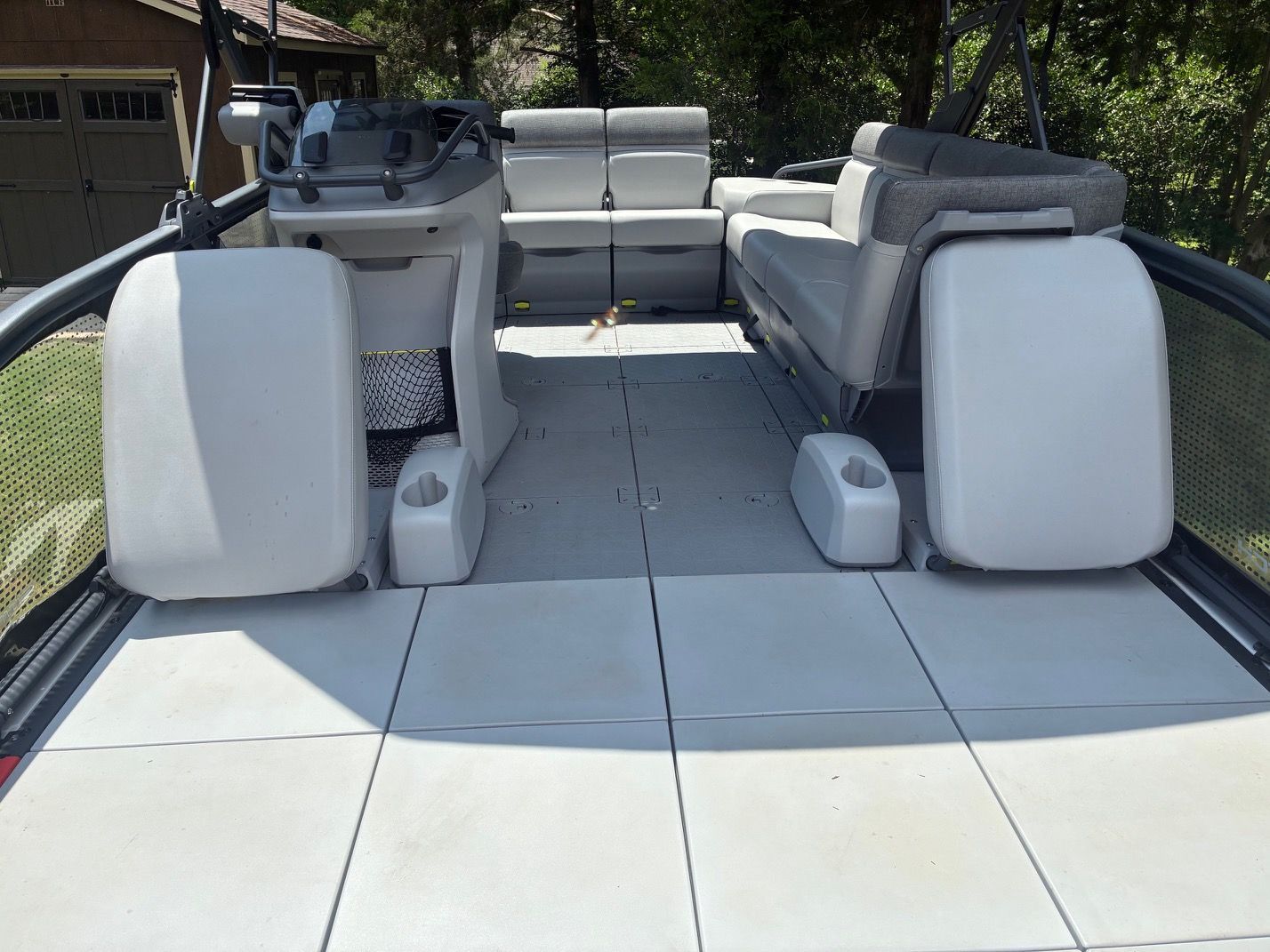 The image shows the deck of a 2023 Sea-Doo Switch Sport 18 with seating areas.