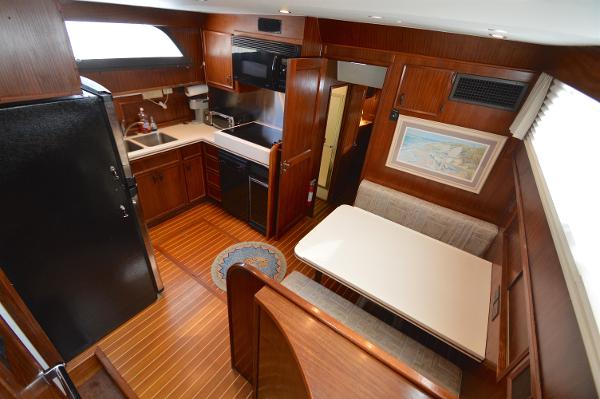 Interior of a 1980 Hatteras 53 Yacht Fisherman with kitchen and dining area.