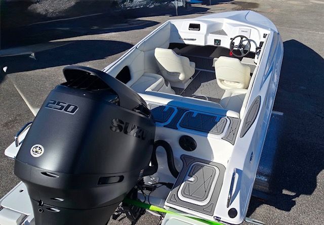 A modern boat with a Suzuki 250 outboard motor and two white seats.