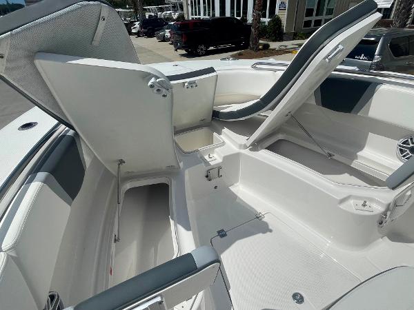 2023 Robalo R270 boat interior with open storage compartments and seating.