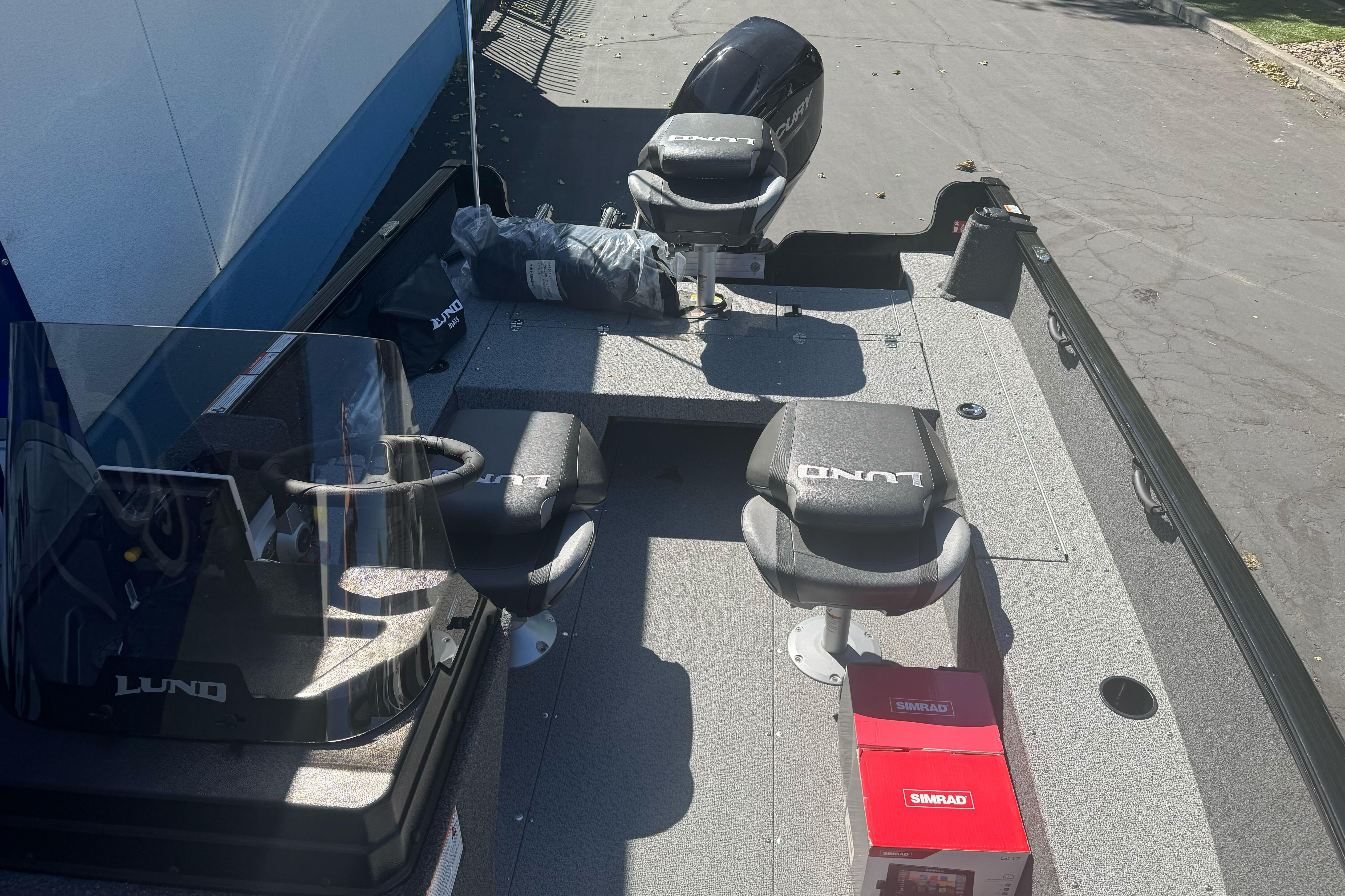 2026 Lund 1650 Rebel XL SS boat interior with seats and steering console.