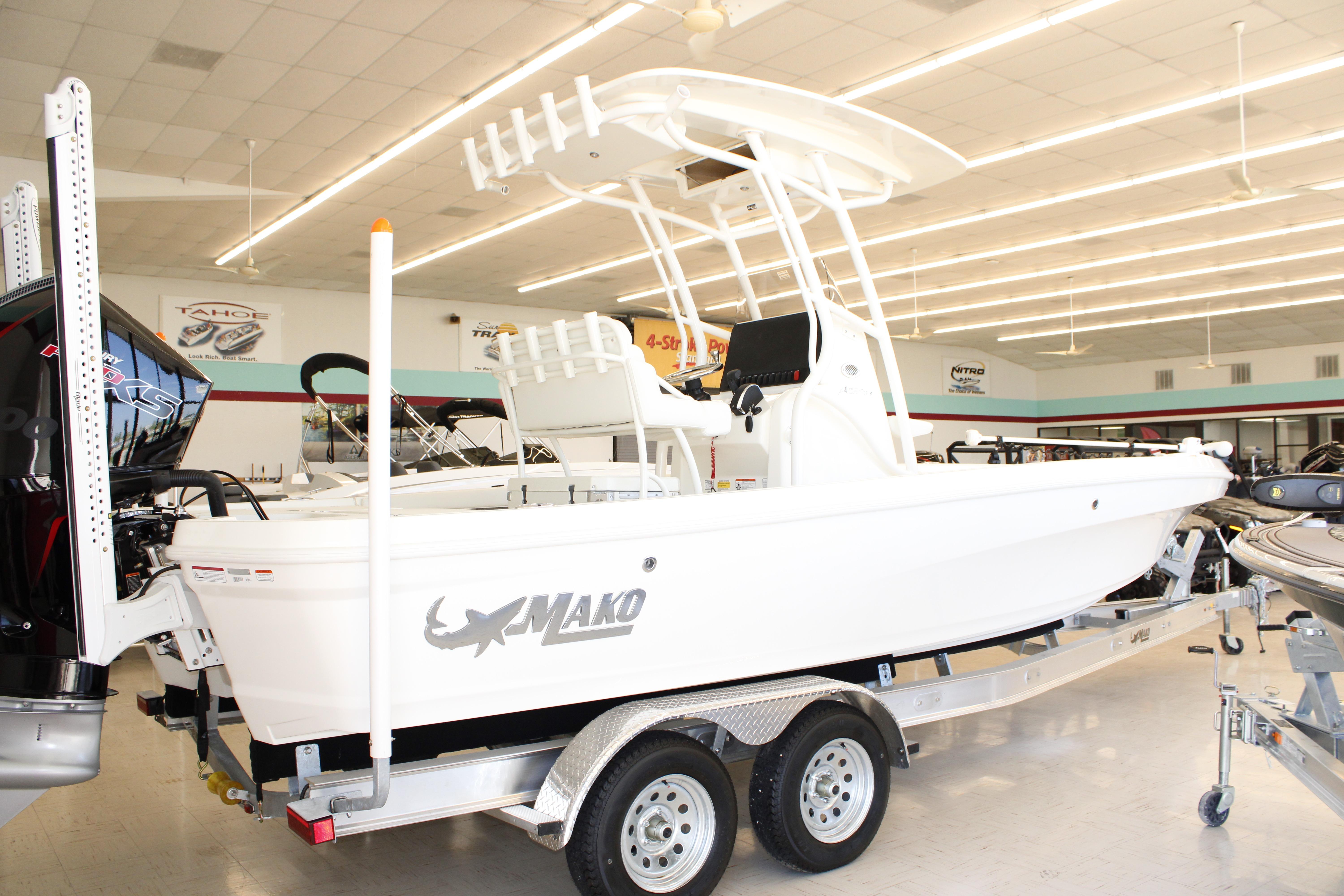 2026 Mako 24 APEX boat displayed indoors on a trailer.
