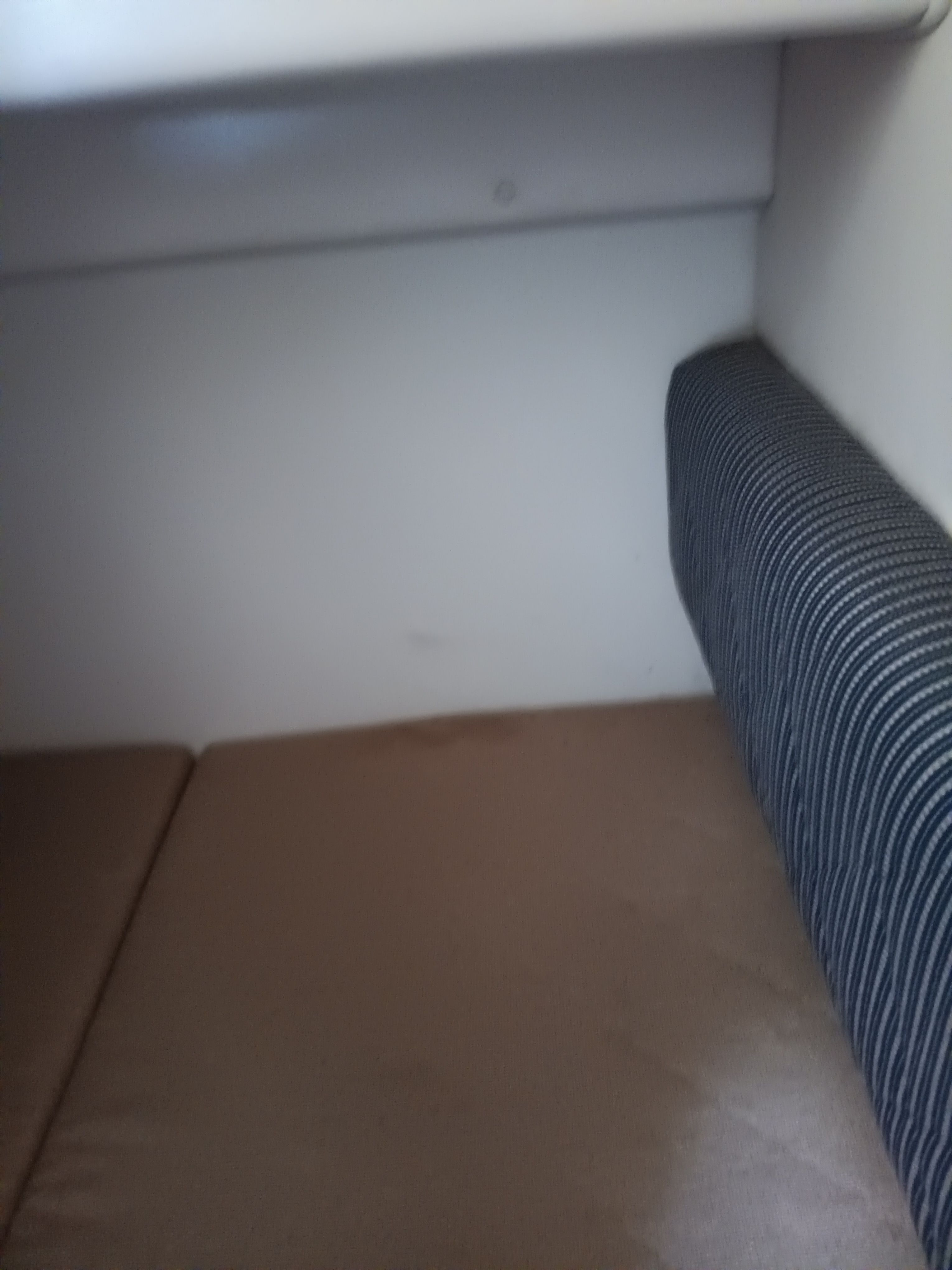 Interior with cushioned seating and walls.