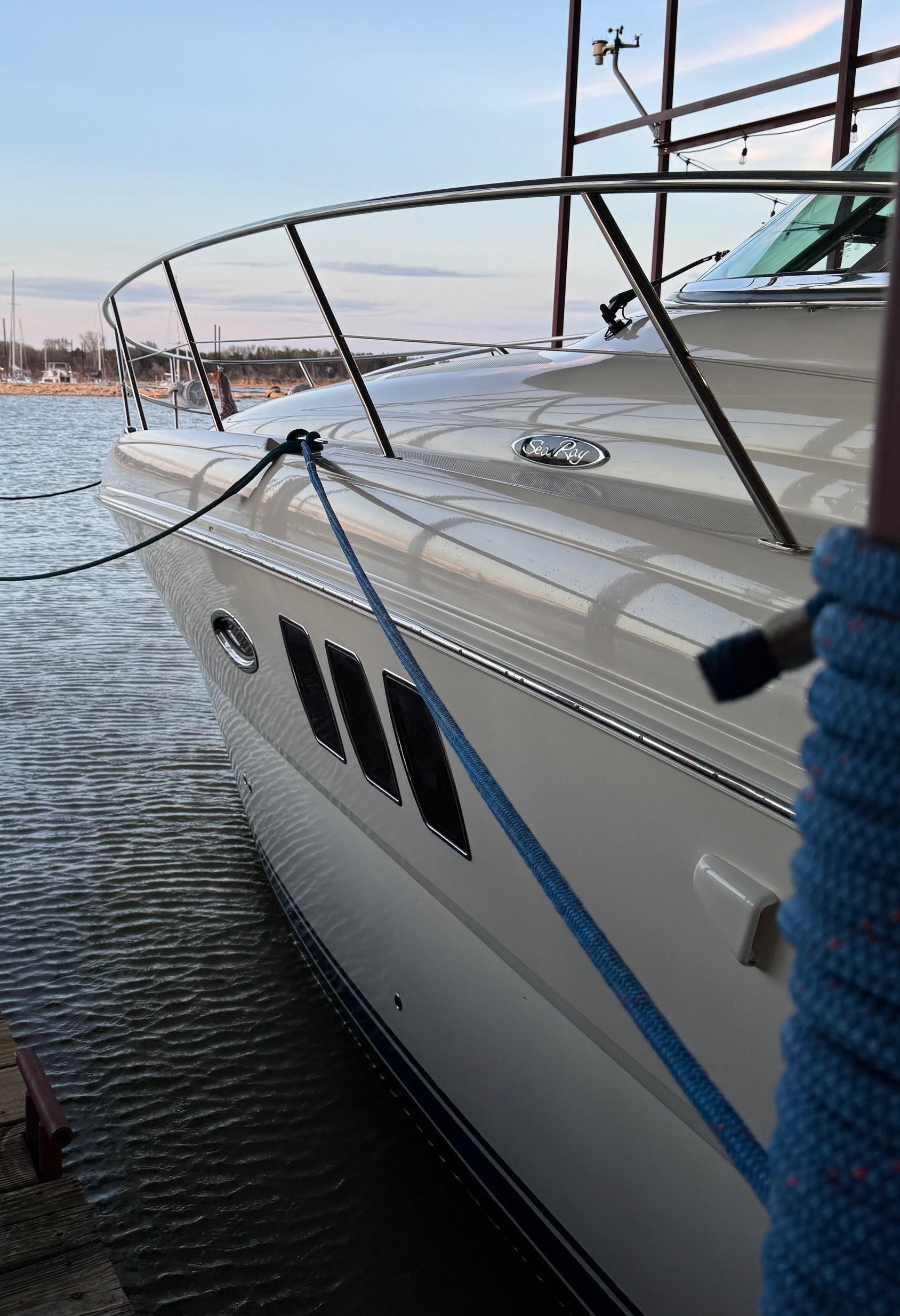 2007 Sea Ray 38 Sundancer yacht docked with blue rope, side view.