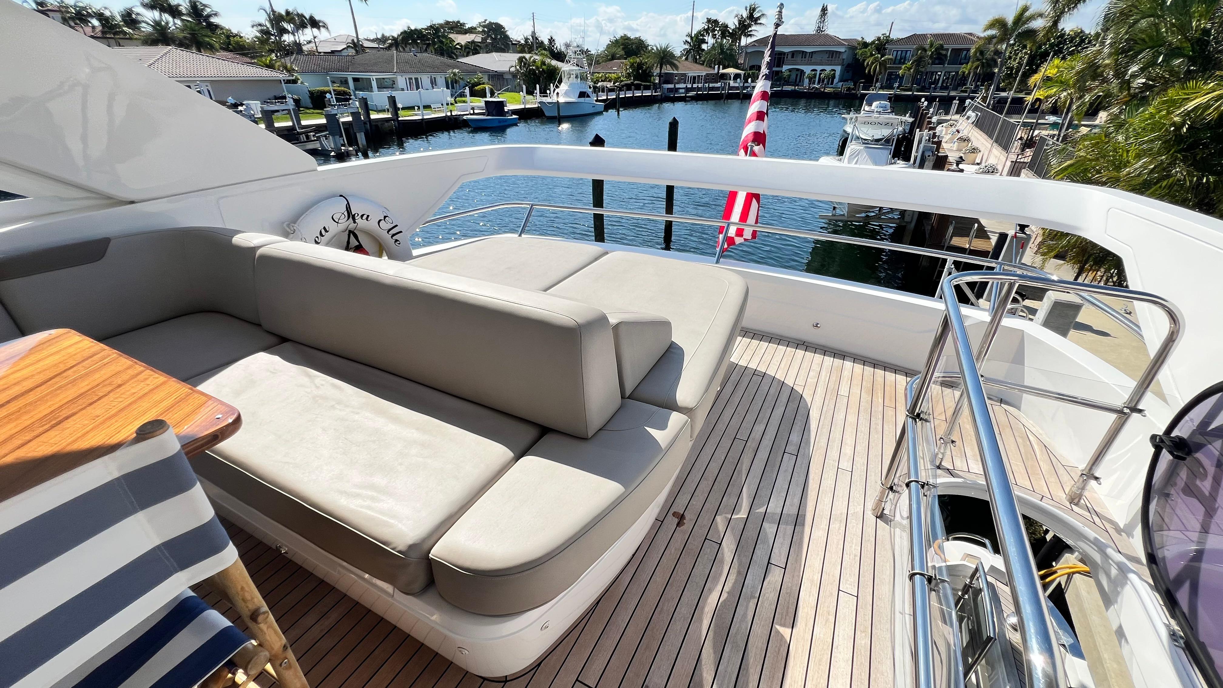 Luxurious 2019 Princess F62 yacht deck with seating, overlooking marina.