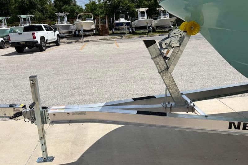 Trailer for 2026 Hurricane SunDeck Sport 2050 OB boat in parking lot.