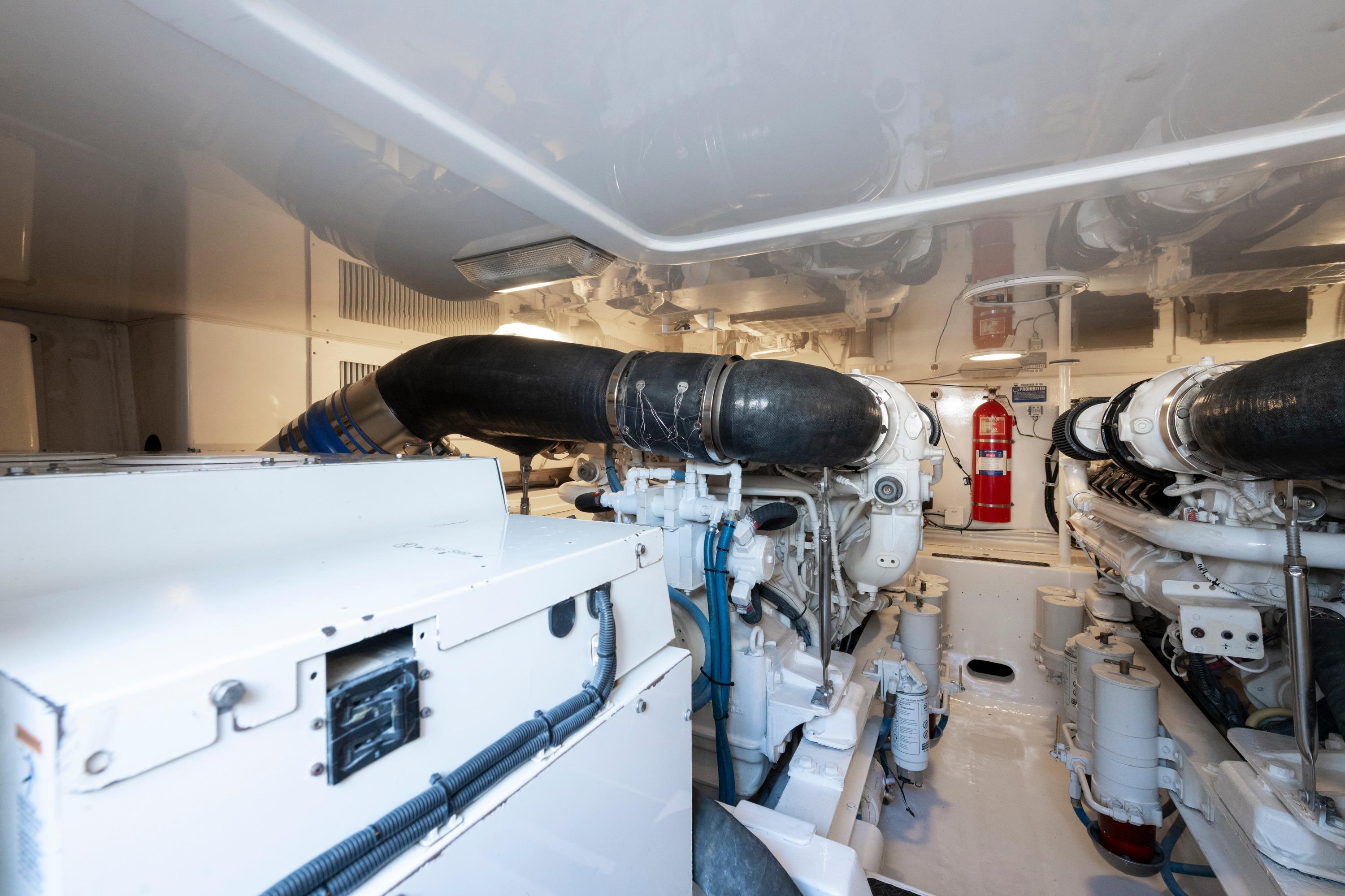 Engine room of 2009 Viking 50 Convertible yacht, featuring dual engines and fire extinguisher.