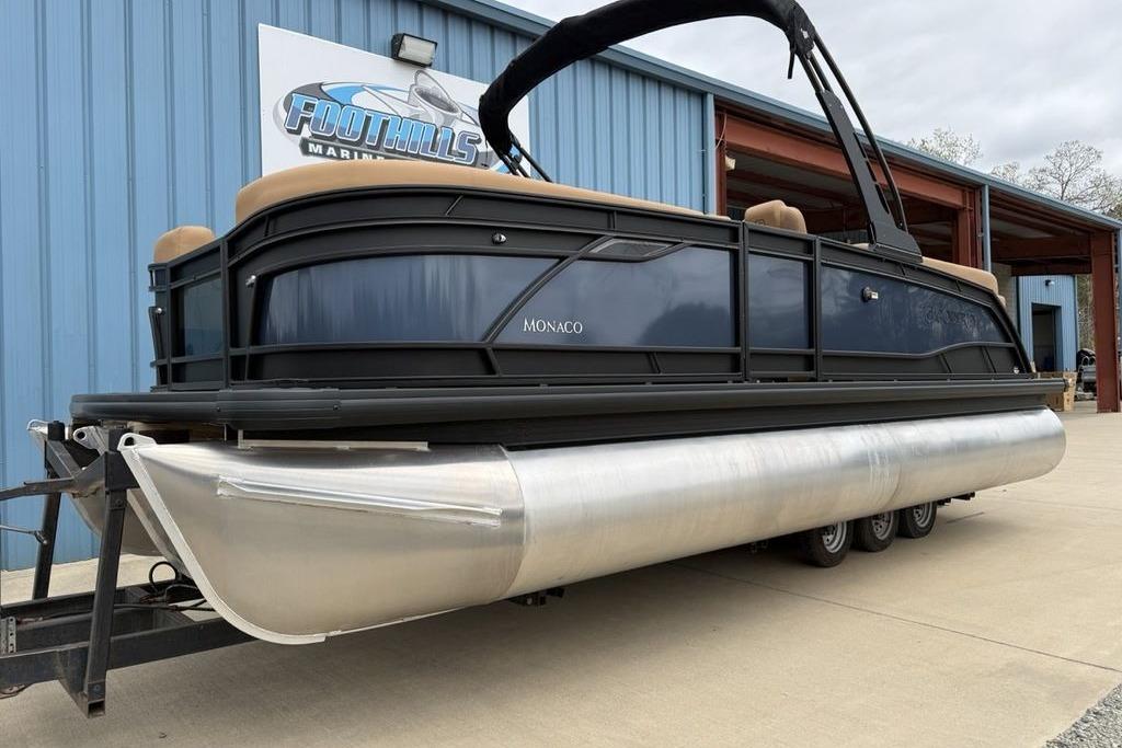 2026 Godfrey Monaco 235 SFLC iMPACT pontoon boat on trailer at marina.