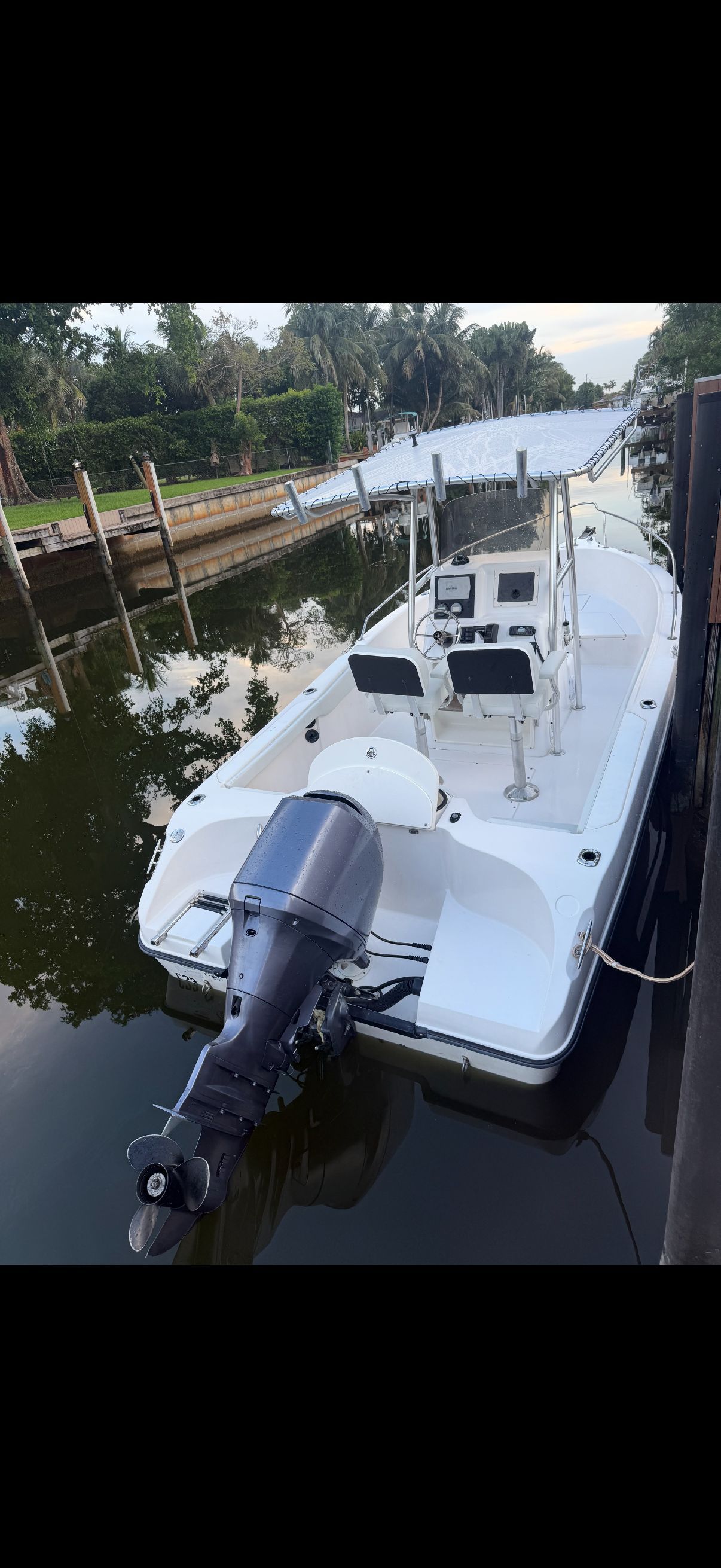 2006 Seaswirl Striper Center Console boat docked.