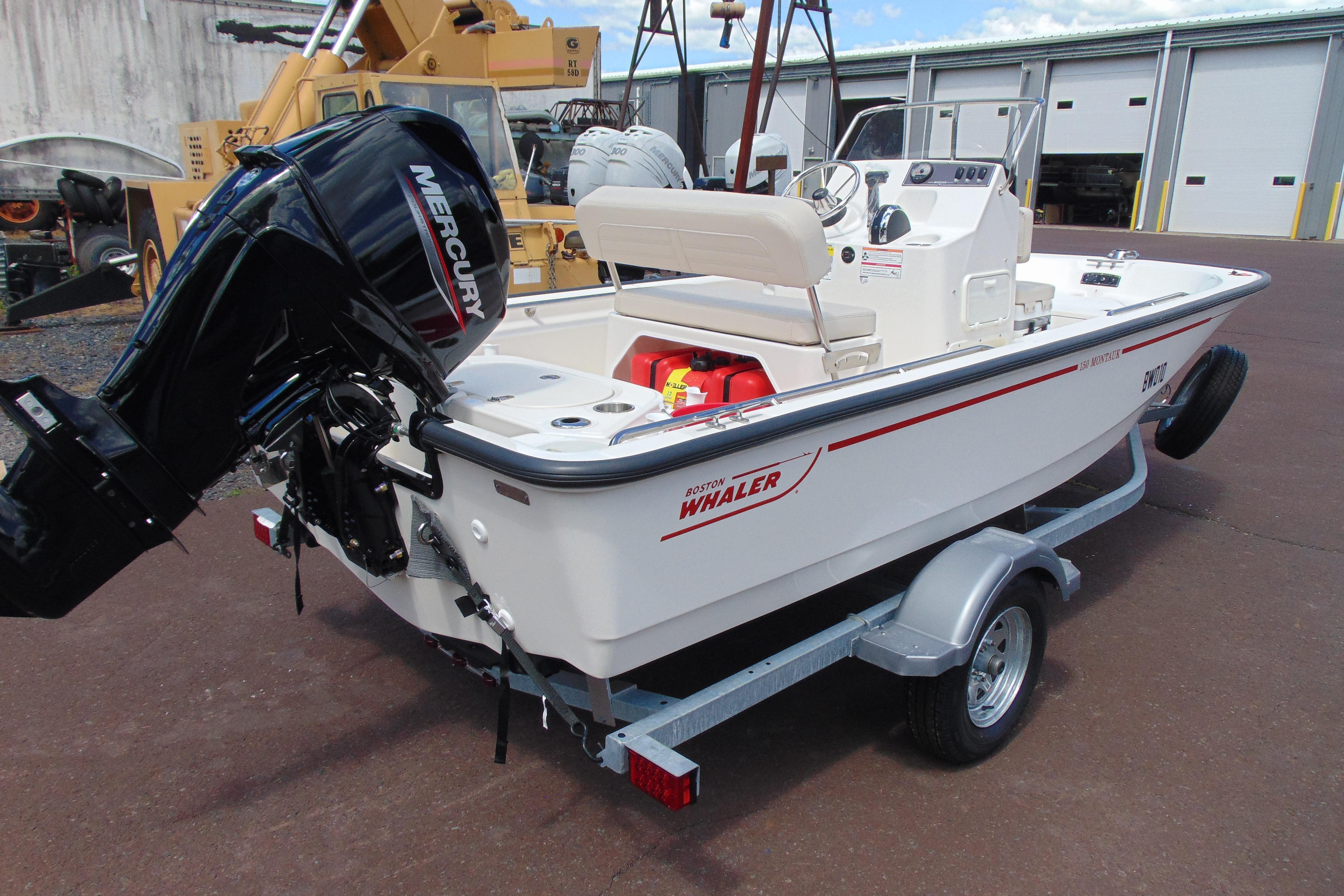 2026 Boston Whaler 150 Montauk boat on trailer with Mercury outboard motor.