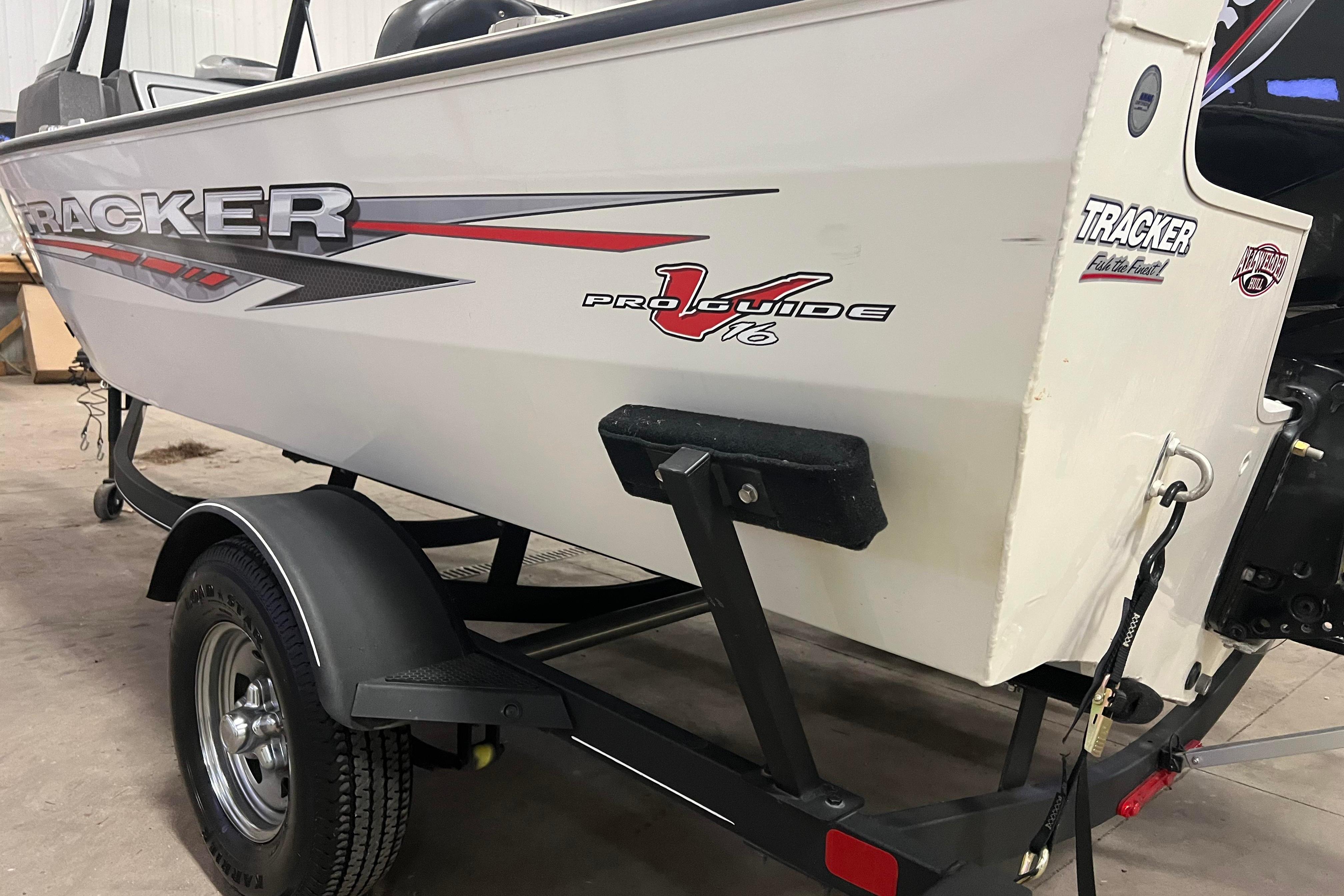2022 Tracker Pro Guide V-16 WT boat on trailer in garage setting.