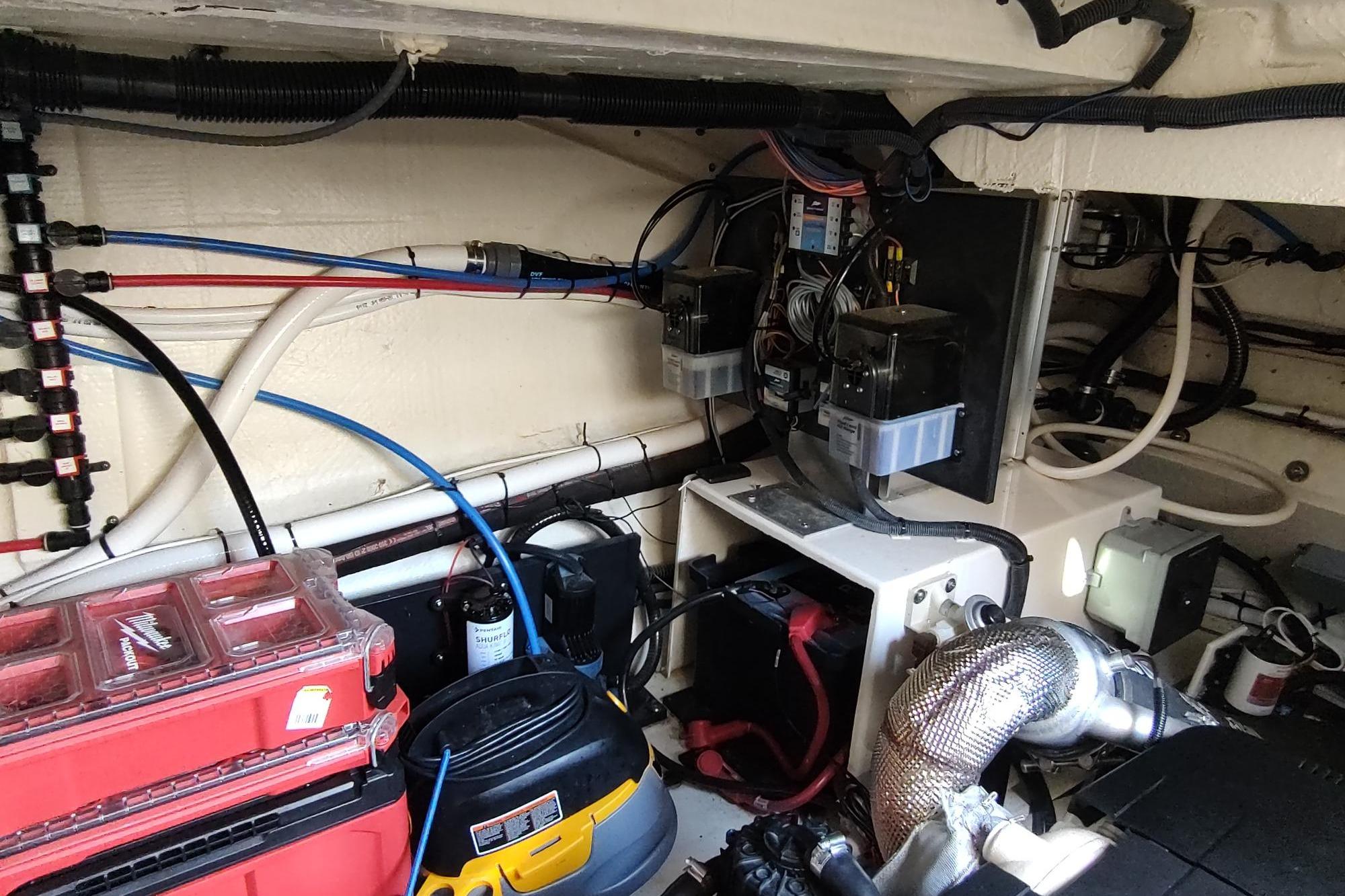 Engine room of 2021 Regal 42 Fly yacht with wiring and equipment.