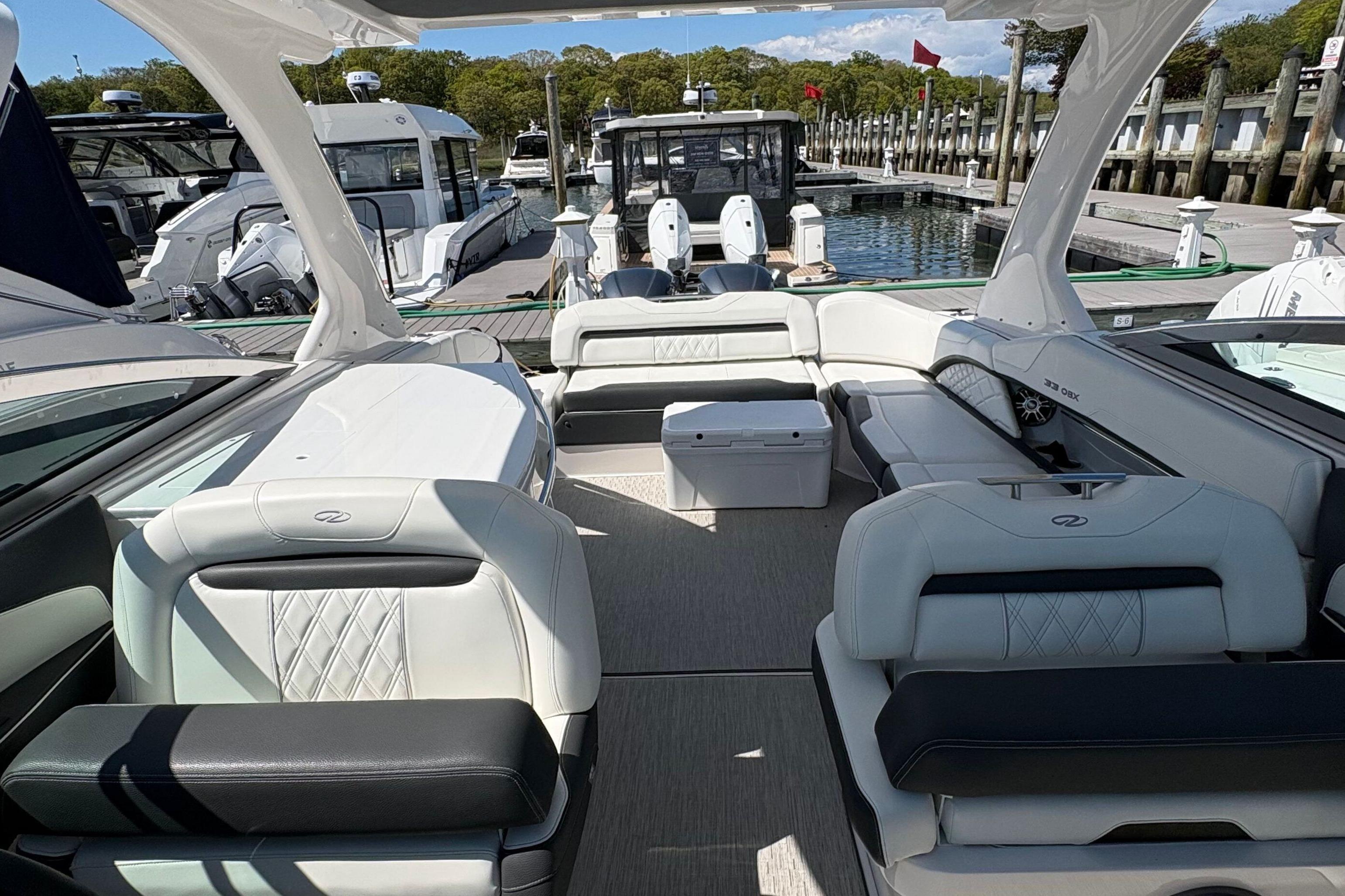 2020 Regal 33 OBX boat interior with luxurious seating at a marina.