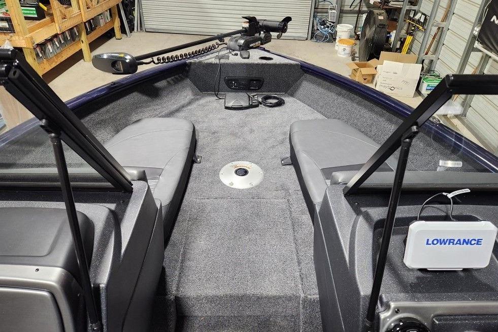 2026 Tracker Pro Guide V-175 Combo boat interior with Lowrance equipment in a garage.
