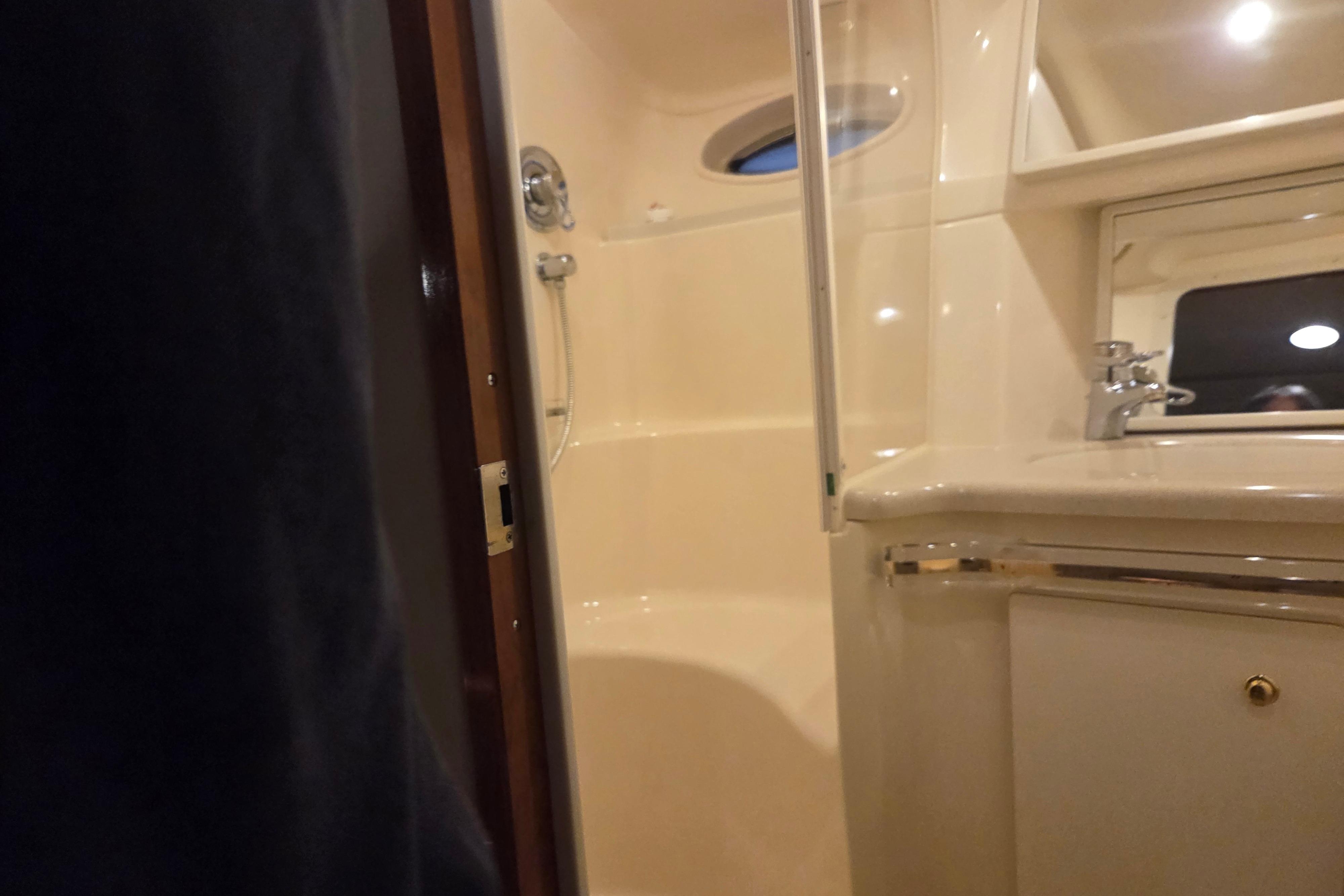 Bathroom interior of 2000 Sea Ray Sundancer 540 yacht, featuring shower and sink.