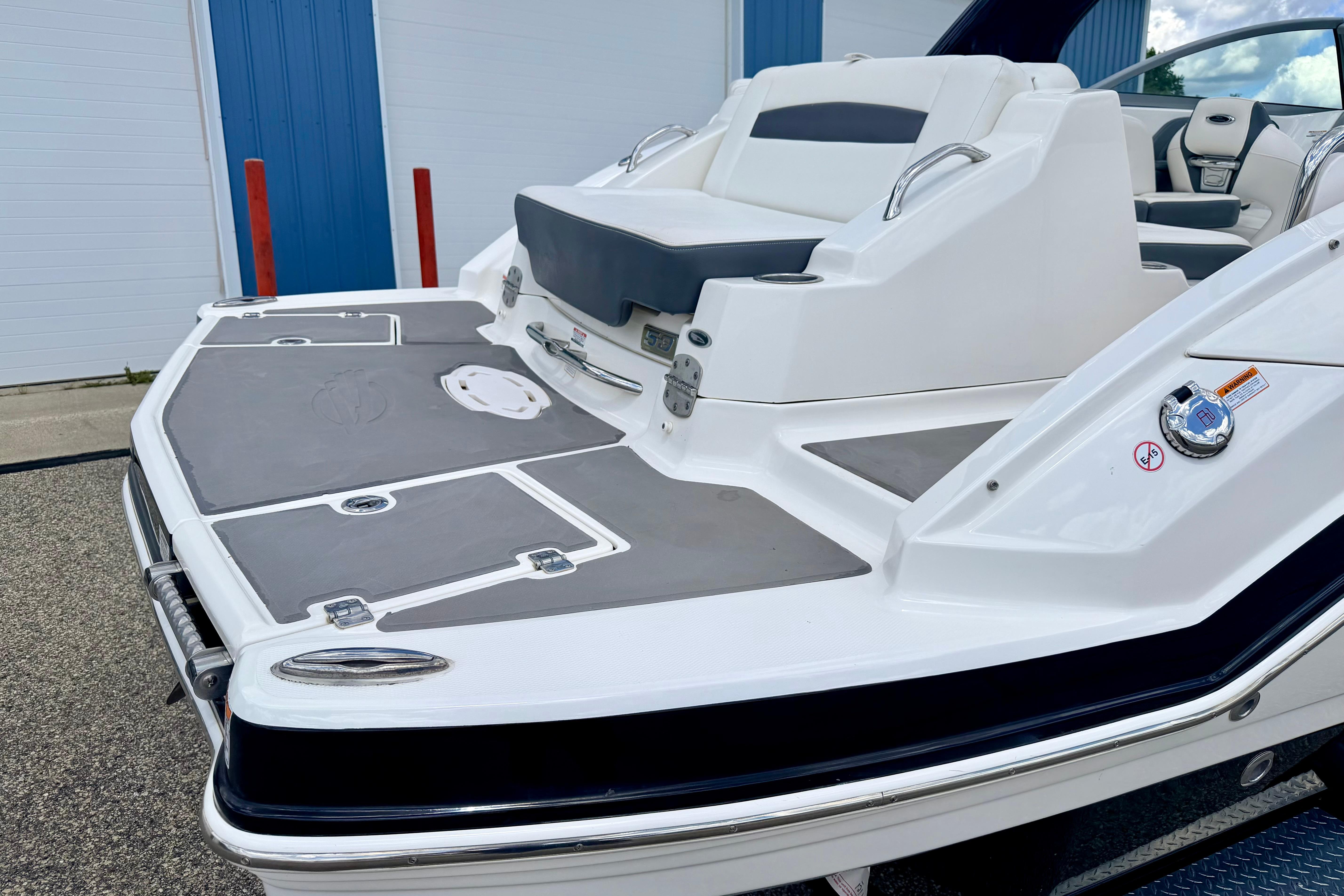 2015 Chaparral Sunesta 264 boat with spacious deck and comfortable seating.