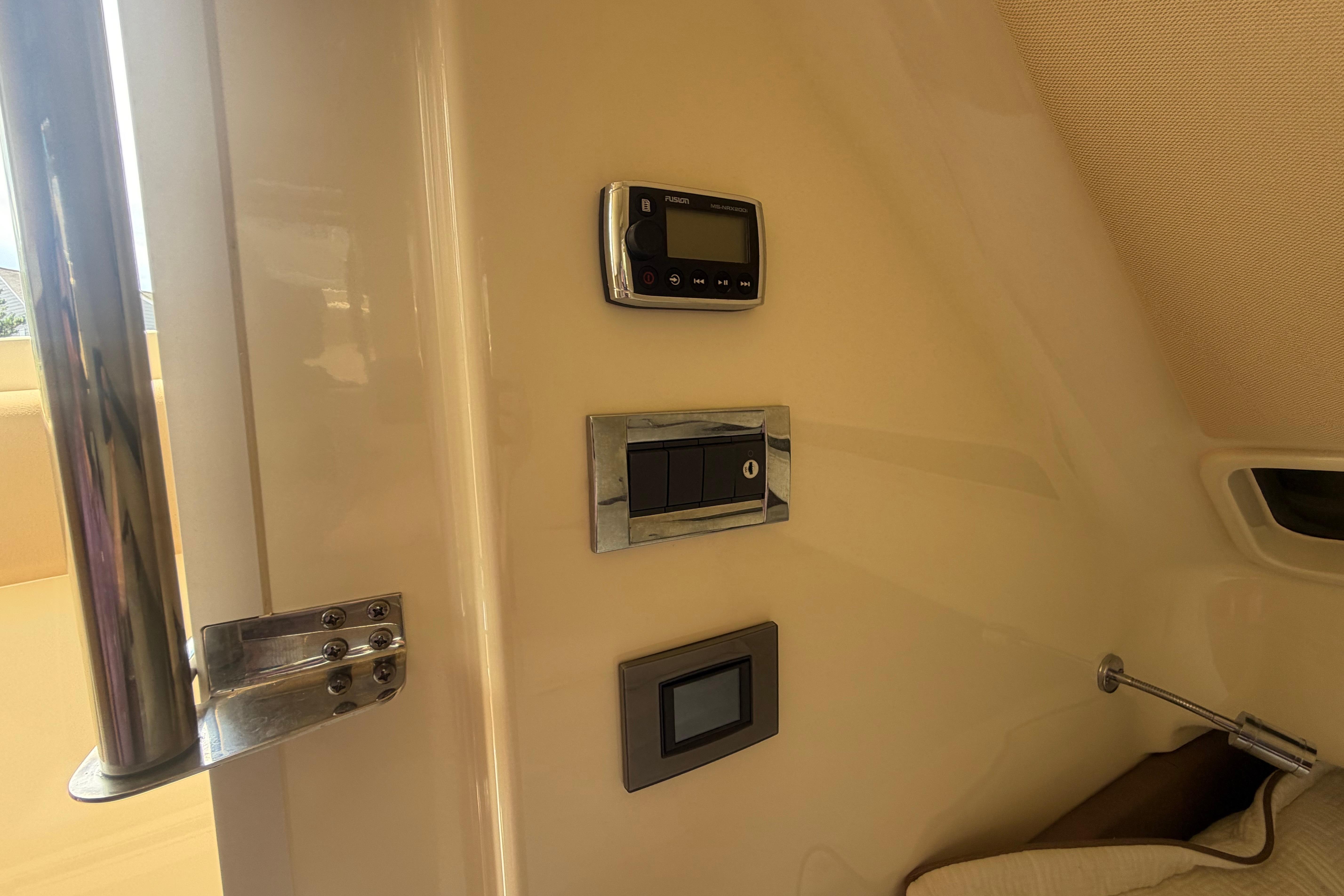 Control panel inside 2017 Chris-Craft Catalina 34 boat cabin, featuring modern switches and displays.