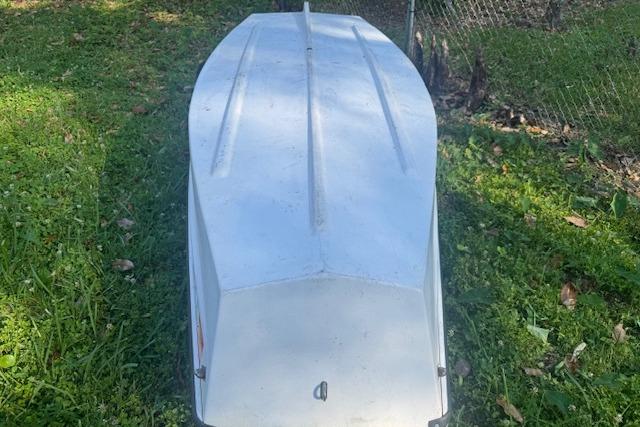 1999 Beacon Boats Pram upside down on grass, showcasing hull design.