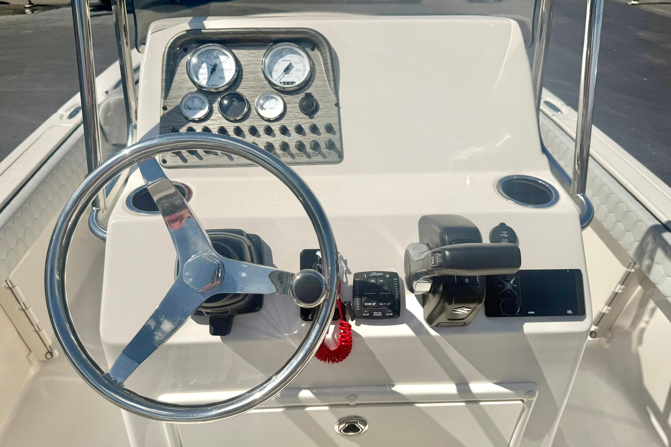 Steering console of 2026 Carolina Skiff 21 Ultra Elite boat with gauges and controls.