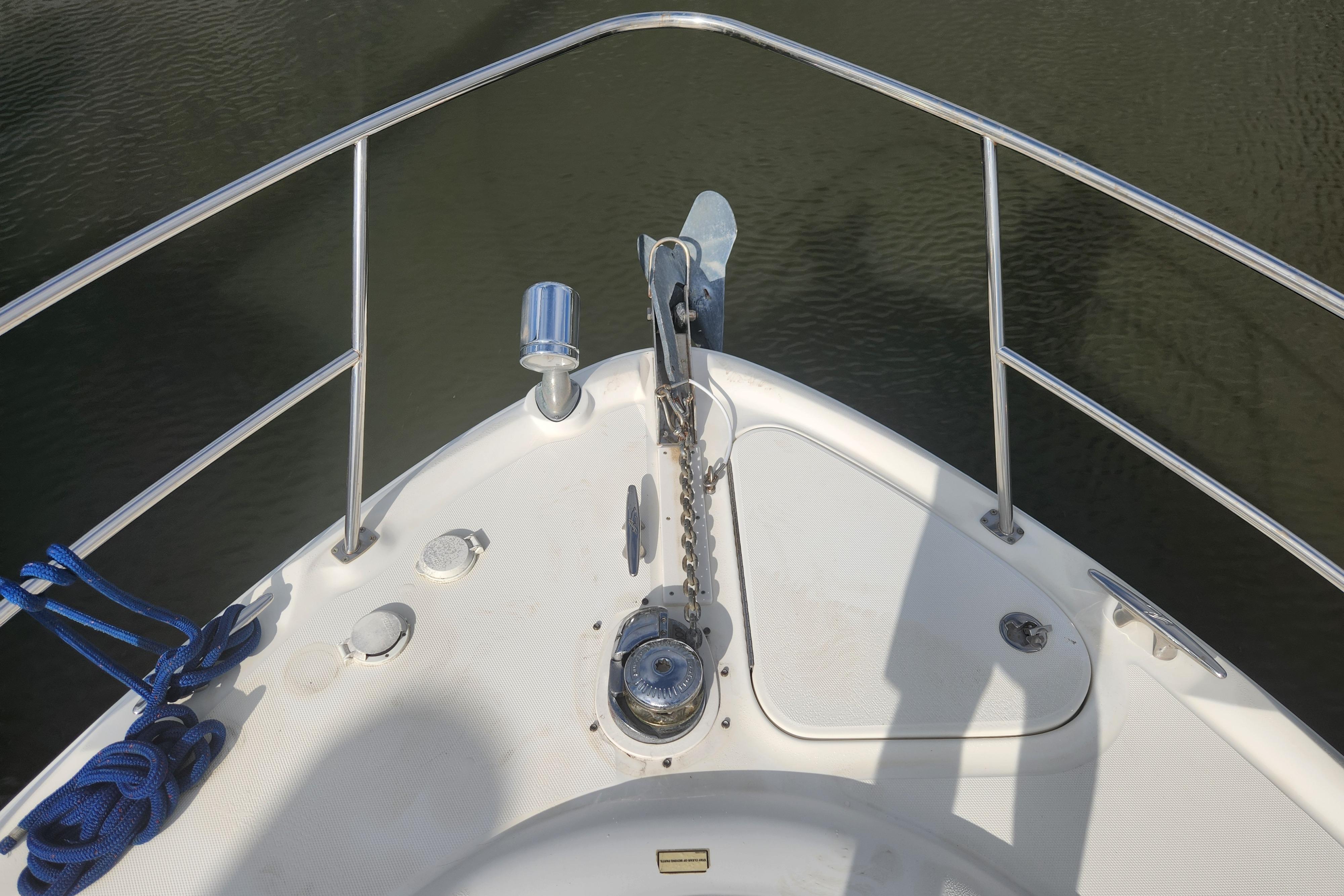 Bow of 2003 Sea Ray 360 Sundancer with anchor and railing.