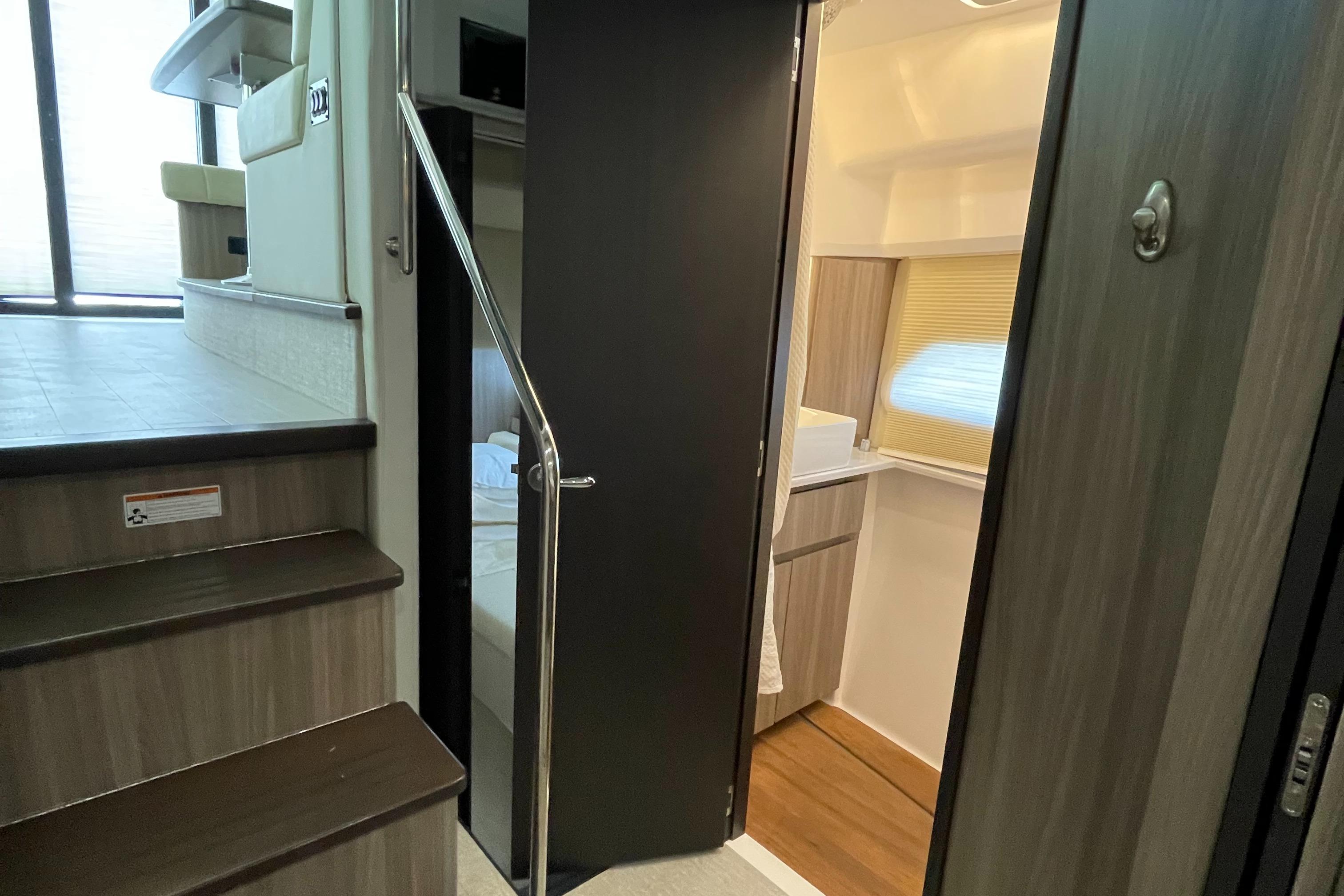 Interior of 2022 Regal 42 FXO yacht, featuring stairs and modern cabin design.
