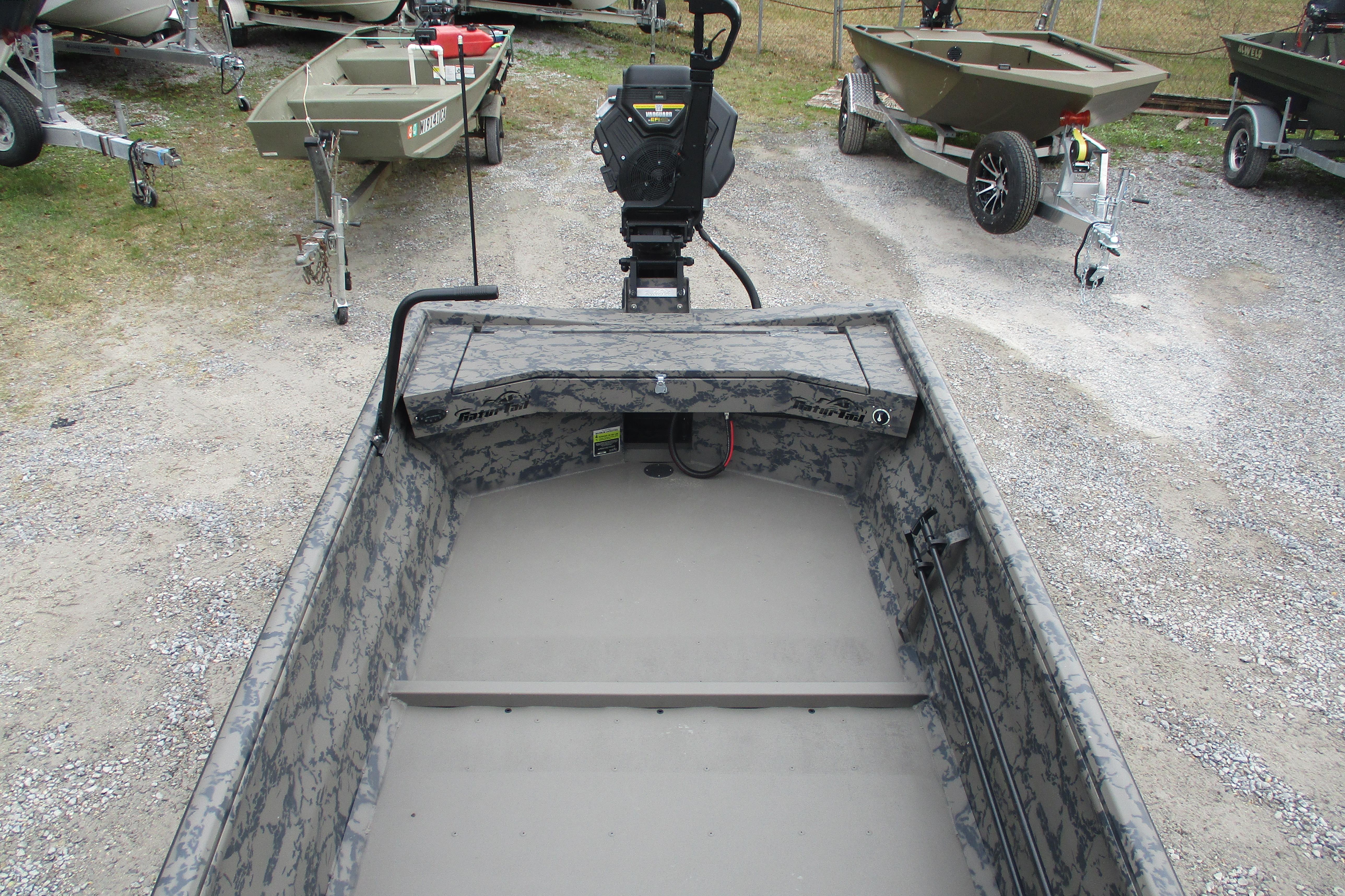 2026 Gator Tail 1754 Extreme boat with camouflage interior, parked on gravel.