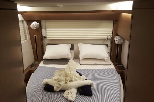 Luxurious cabin interior of 2019 Lagoon 50 yacht with neatly arranged bed.