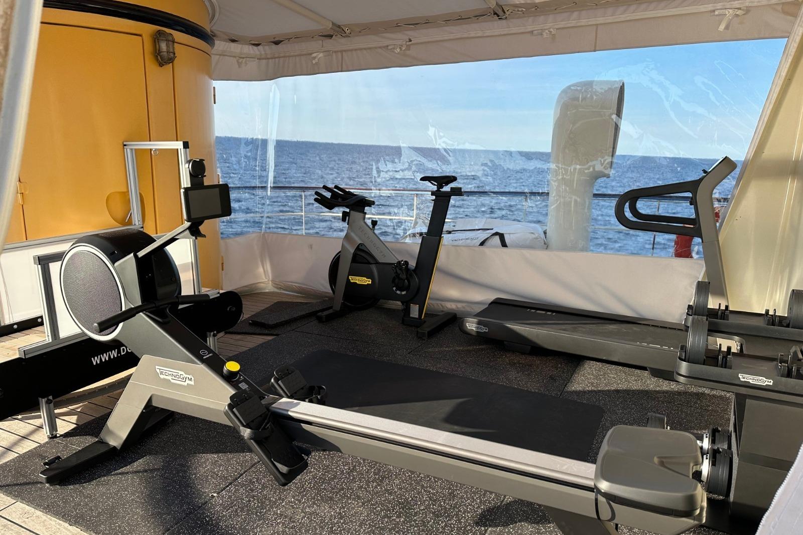 Fitness equipment on a 1956 custom converted tugboat with ocean view.