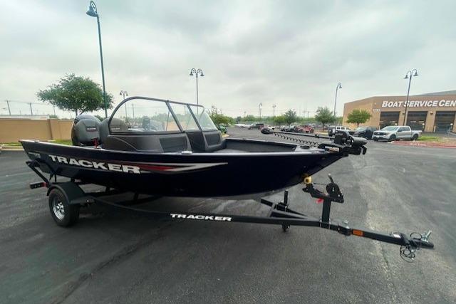 2026 Tracker Pro Guide V-16 WT boat on trailer in parking lot.