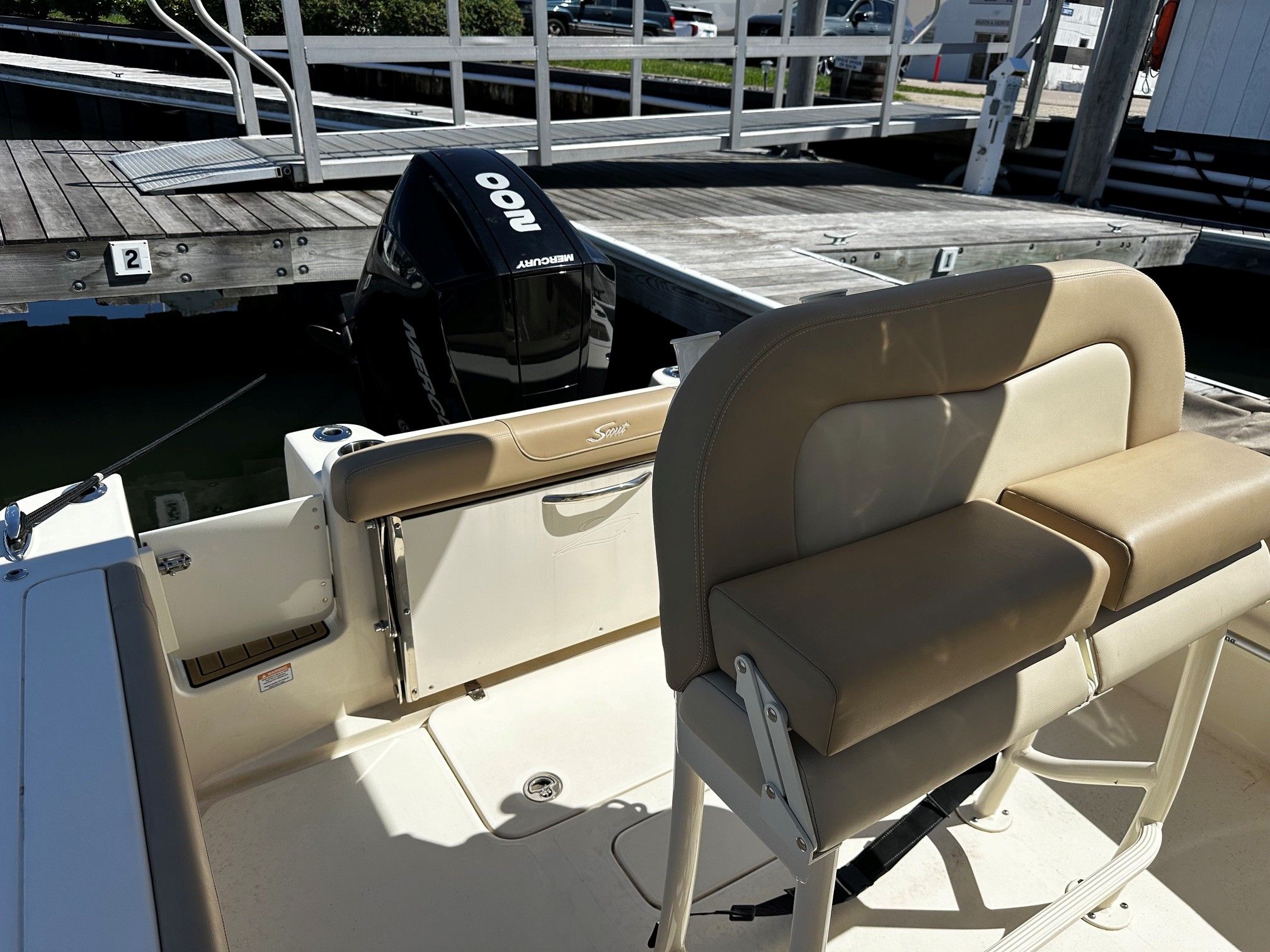 Scout 210XSF boat at dock with Mercury engine.