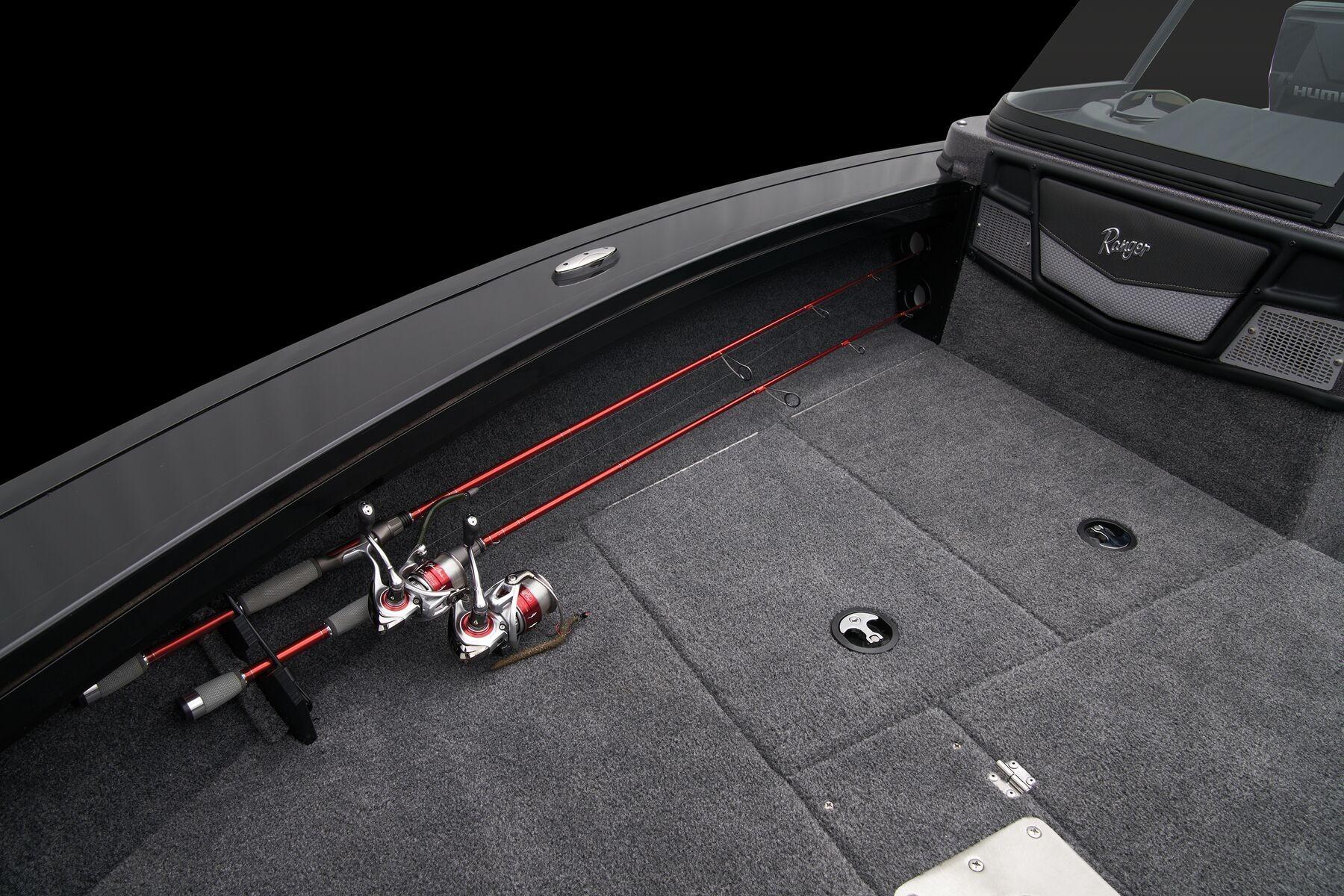 Interior of 2026 Ranger VX1888 WT boat with fishing rods and carpeted deck.