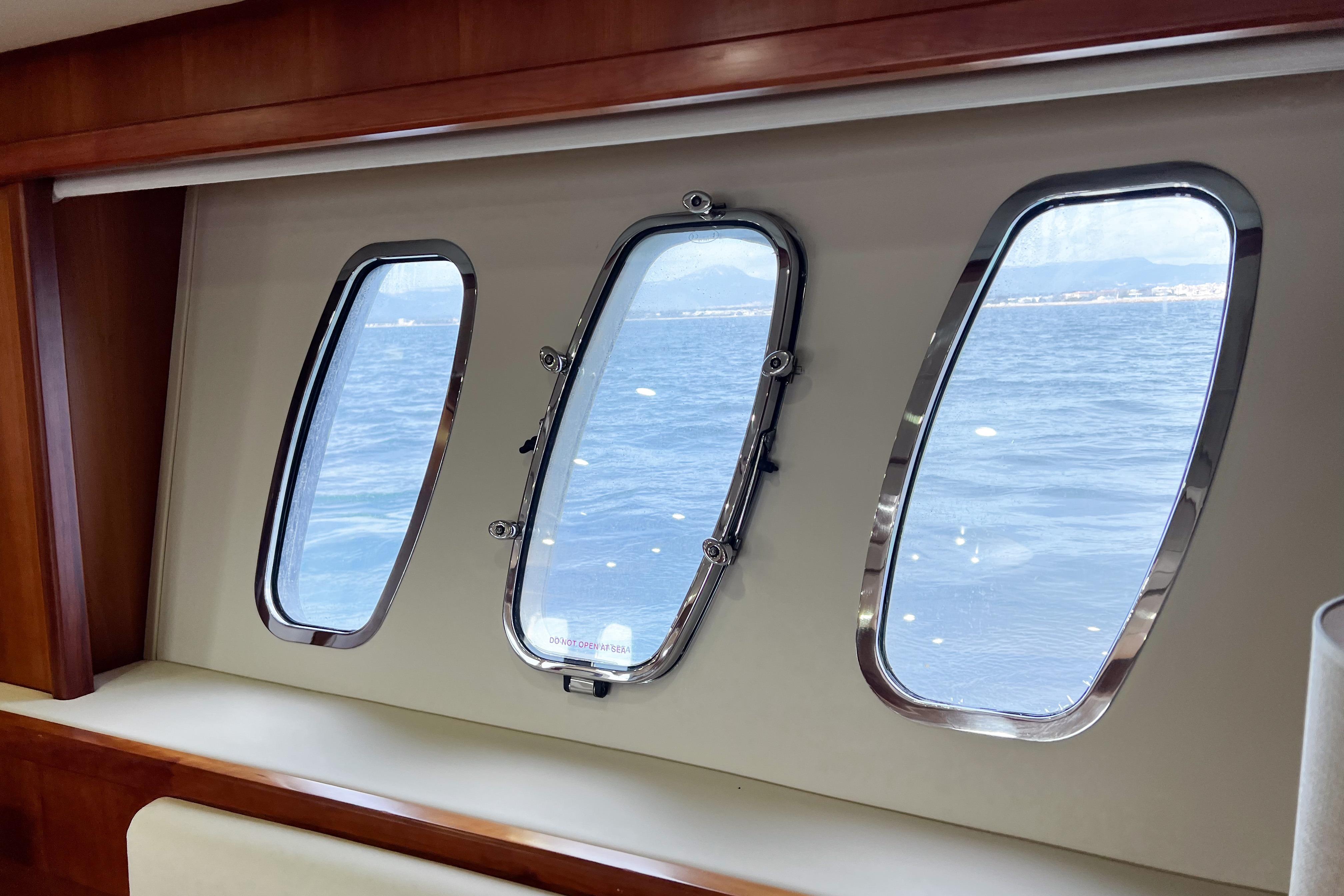 Interior view of 2007 Sunseeker Manhattan 66 yacht windows overlooking the sea.
