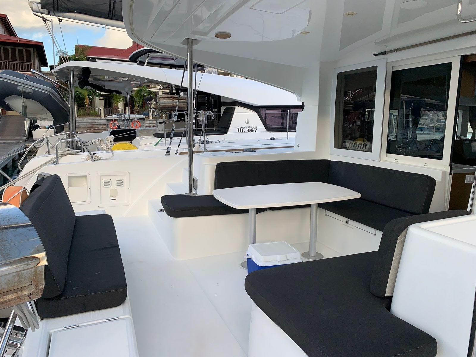 Spacious deck of 2020 Lagoon 40 catamaran with seating and table.