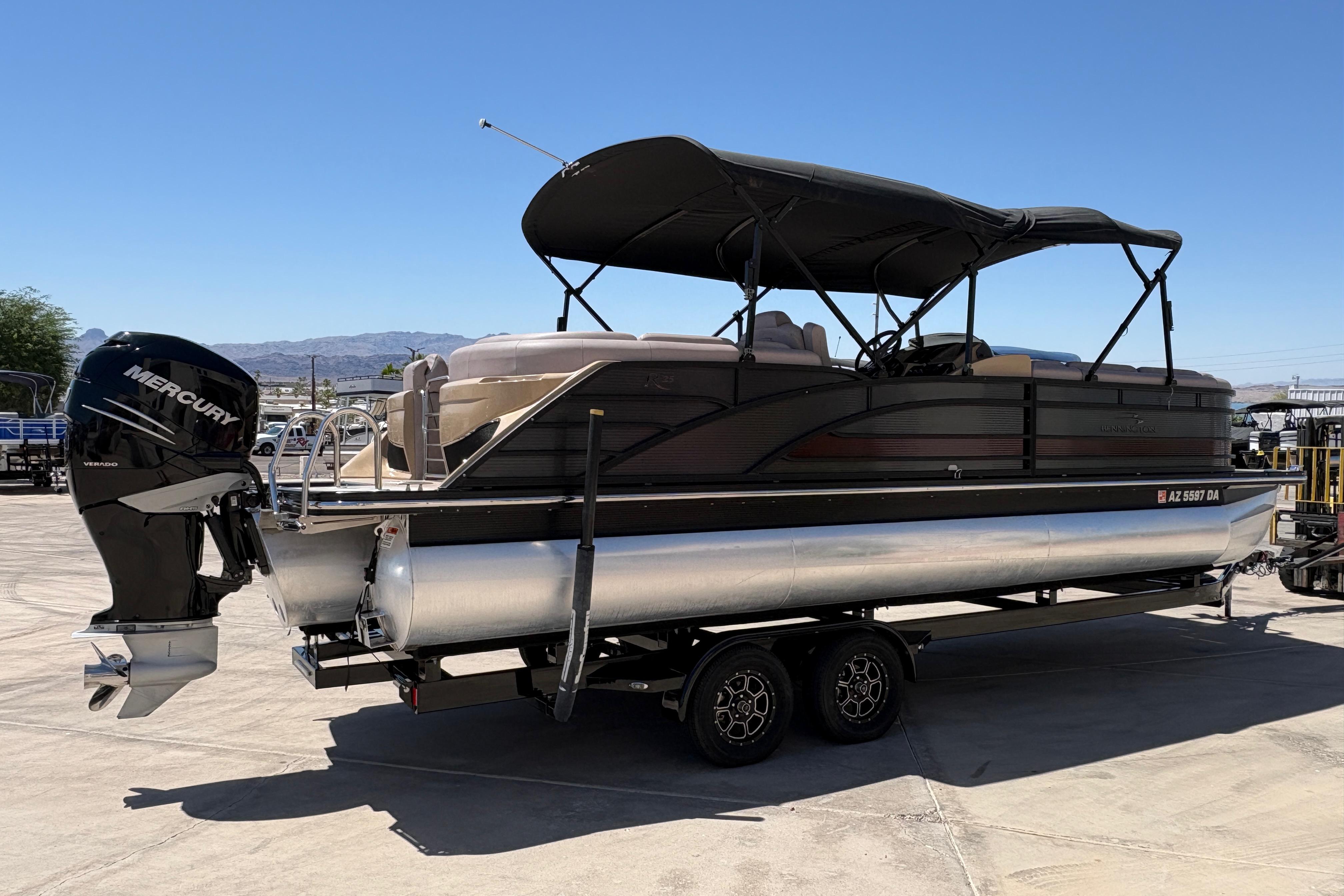 2017 Bennington 25 RSR pontoon boat with Mercury engine on trailer, sunny day.
