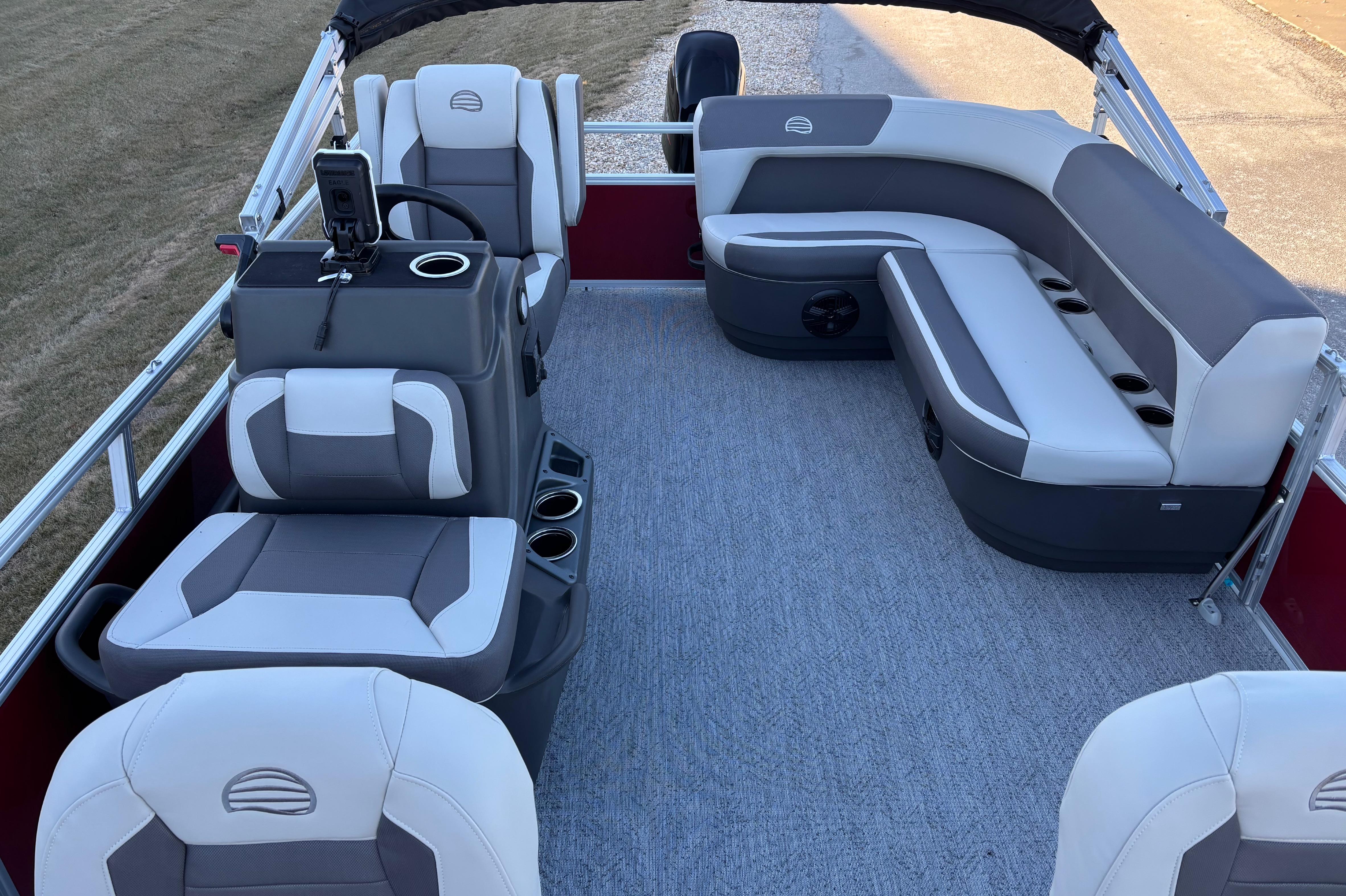 2026 Sun Tracker Bass Buggy 16 XL Select pontoon boat interior with gray seating and steering console.