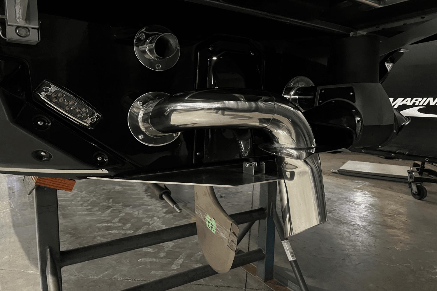 2023 Nautique Super Air Nautique S25 boat exhaust and propeller detail.