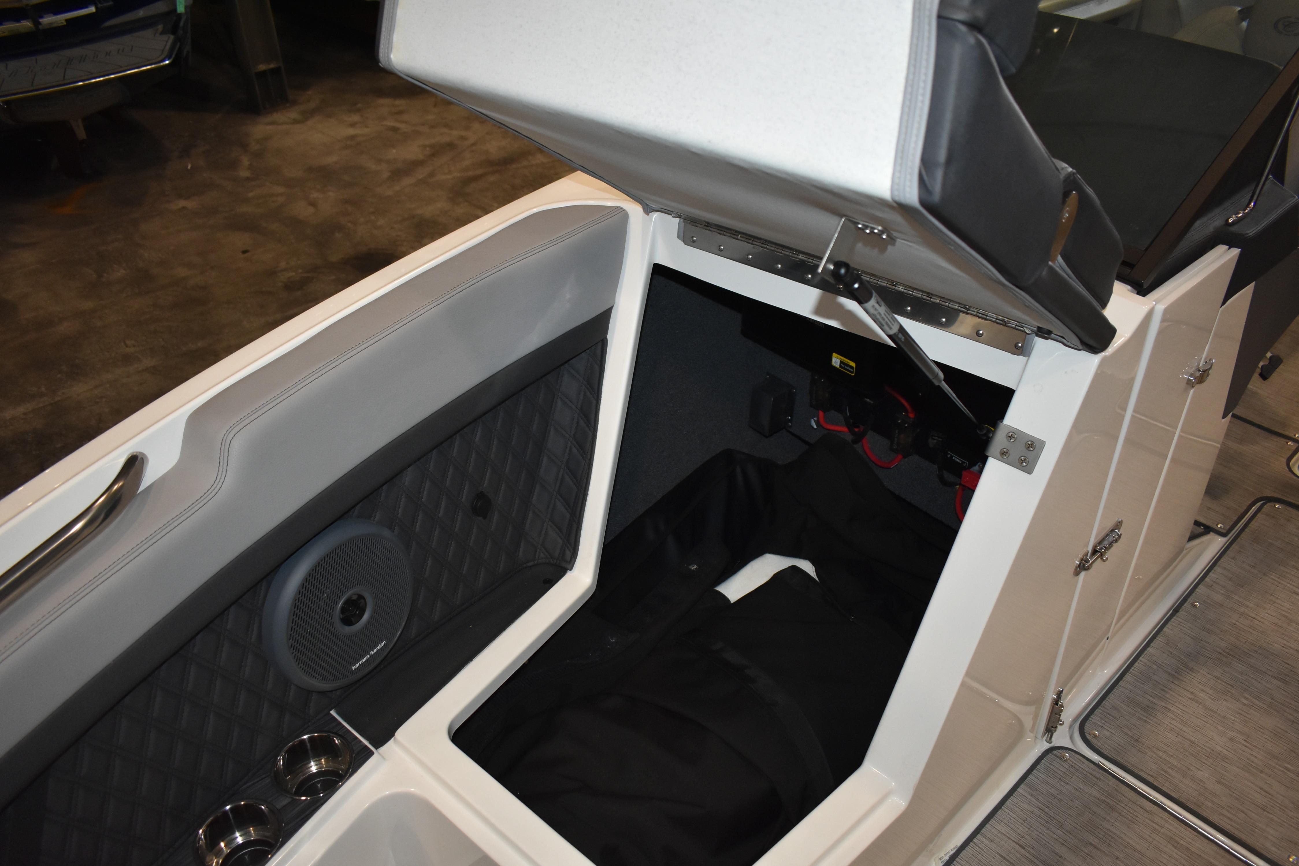 2023 Cobalt R8 boat interior storage compartment with speaker and cup holders.