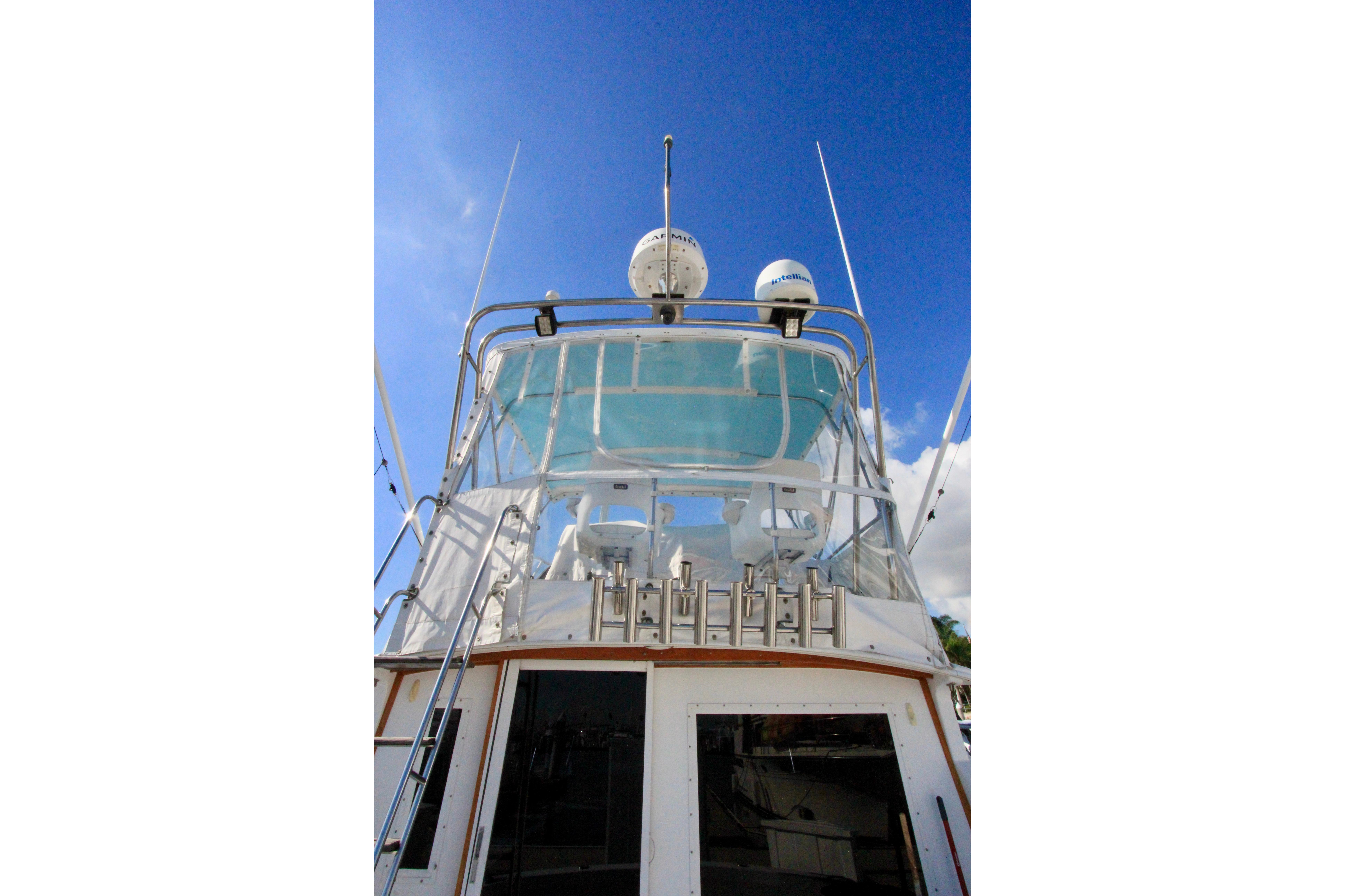 1982 Bertram 35 Flybridge yacht with clear blue sky background.