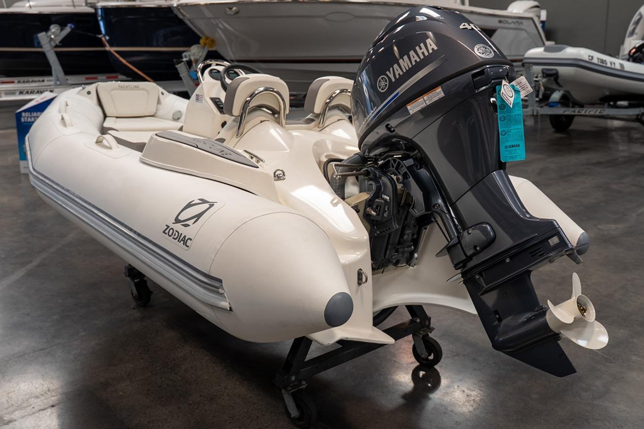 2026 Zodiac Yachtline 360 inflatable boat with Yamaha outboard motor in showroom.