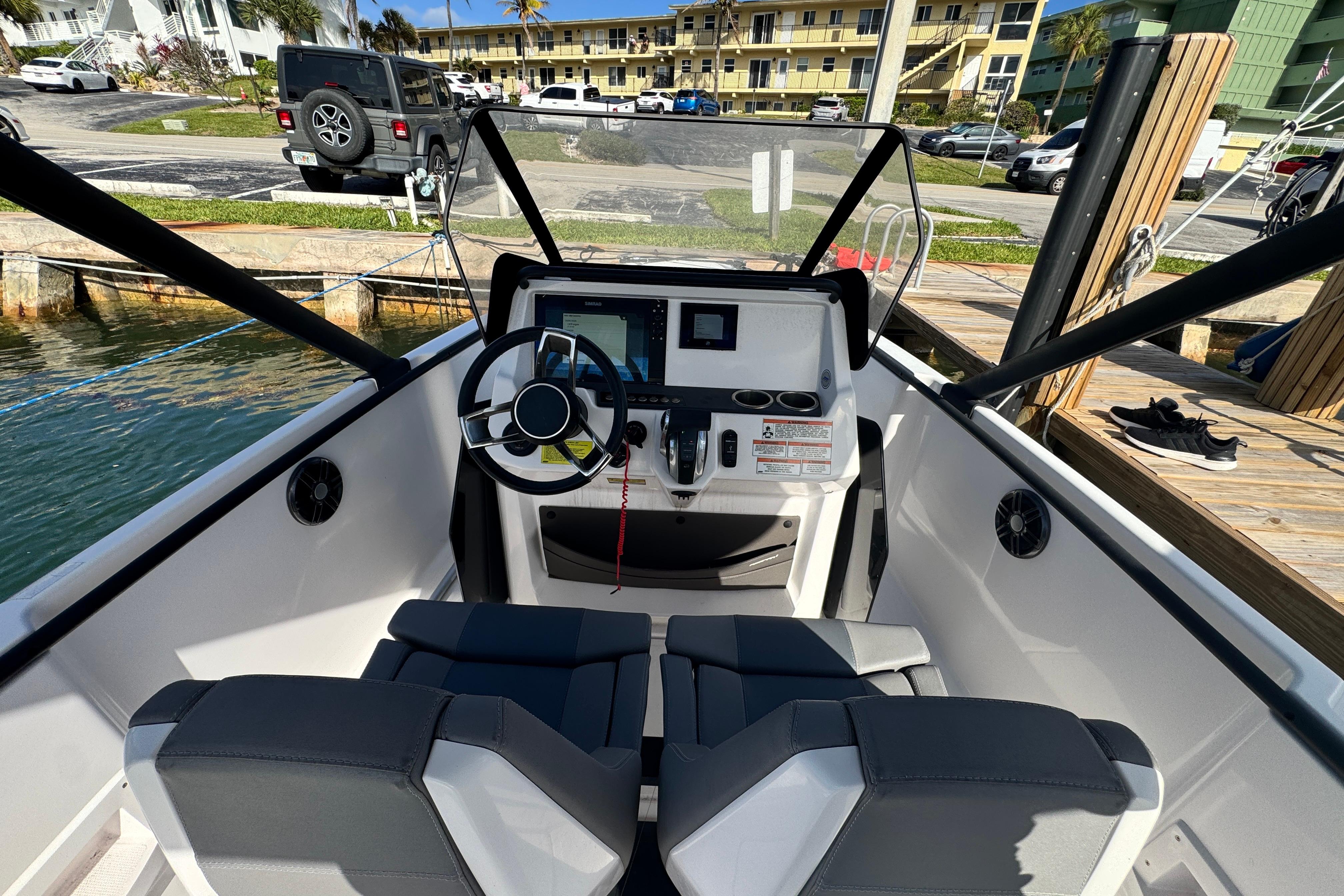 Cockpit view of 2022 Axopar 22 T-Top boat with modern steering and controls.