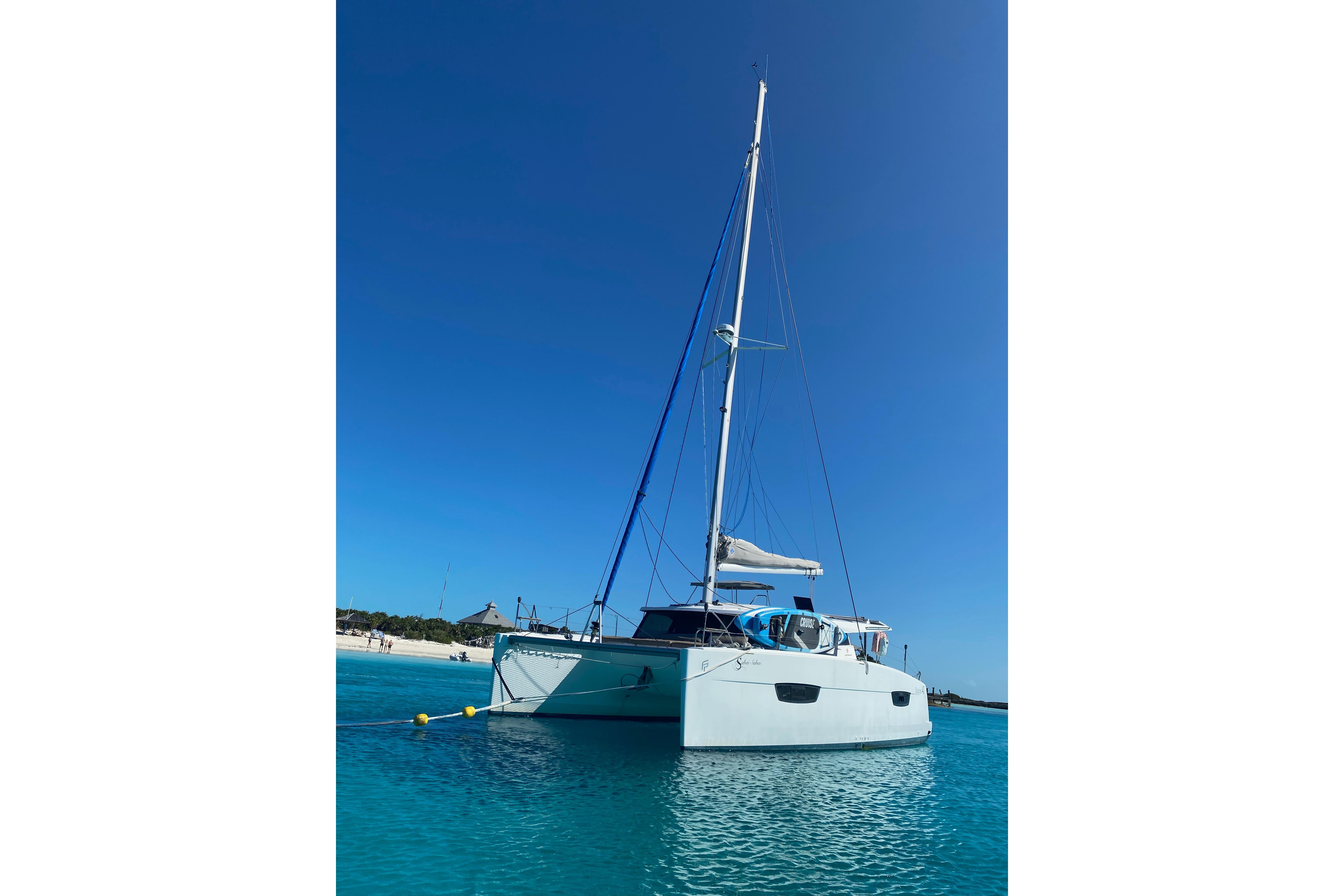 2018 Fountaine Pajot Lucia 40 catamaran anchored in clear blue waters.