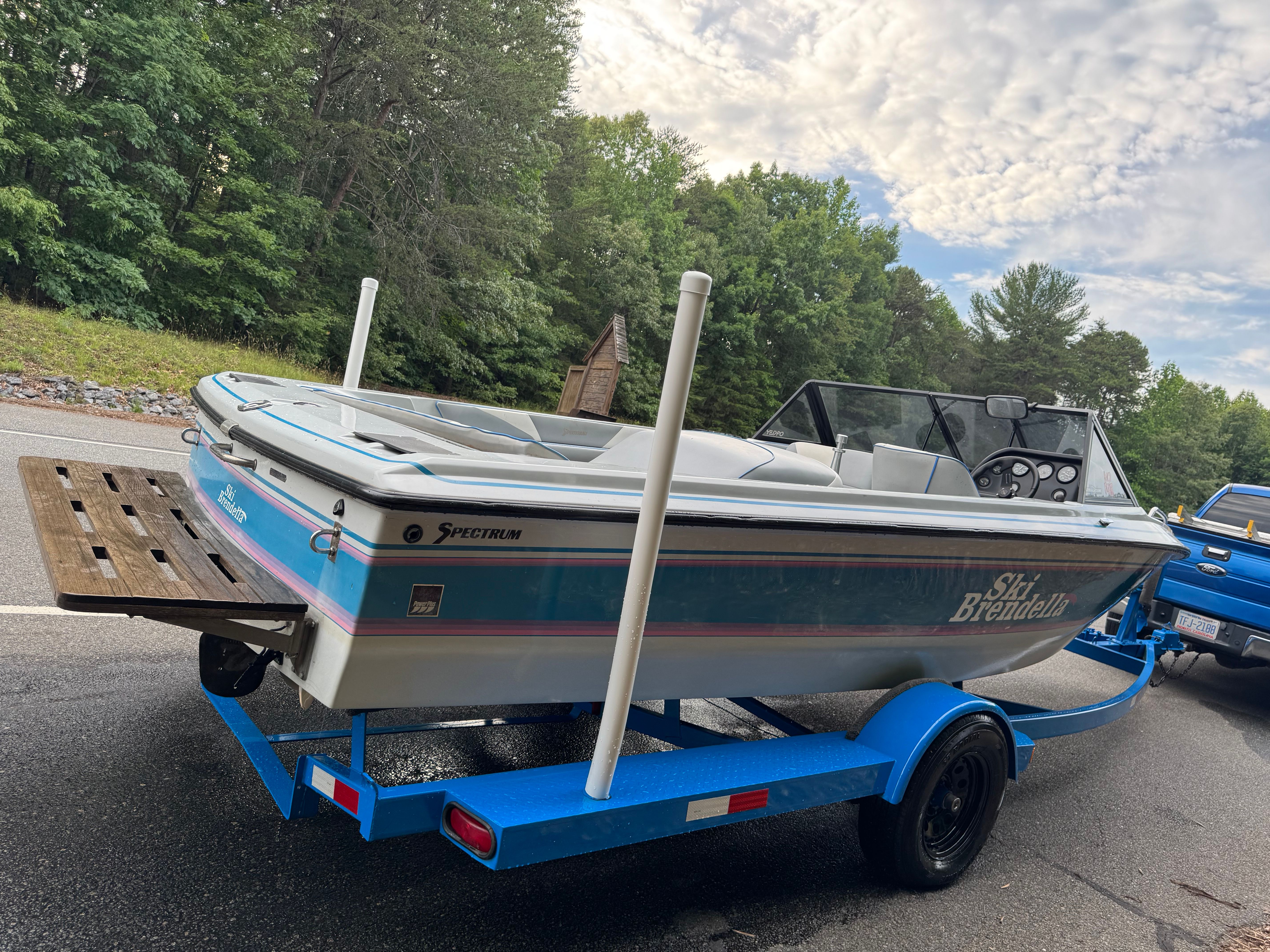 1992 Ski Brendella Spectrum on blue trailer, parked on road.